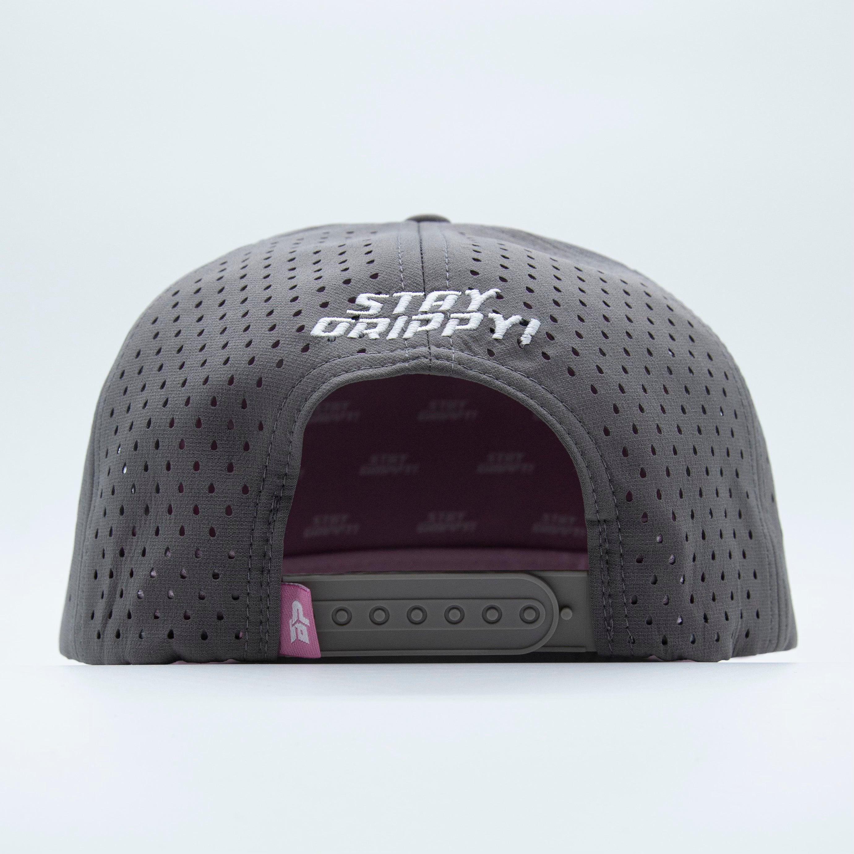 Back of a gray perforated hat with white embroidery and a pink detail.