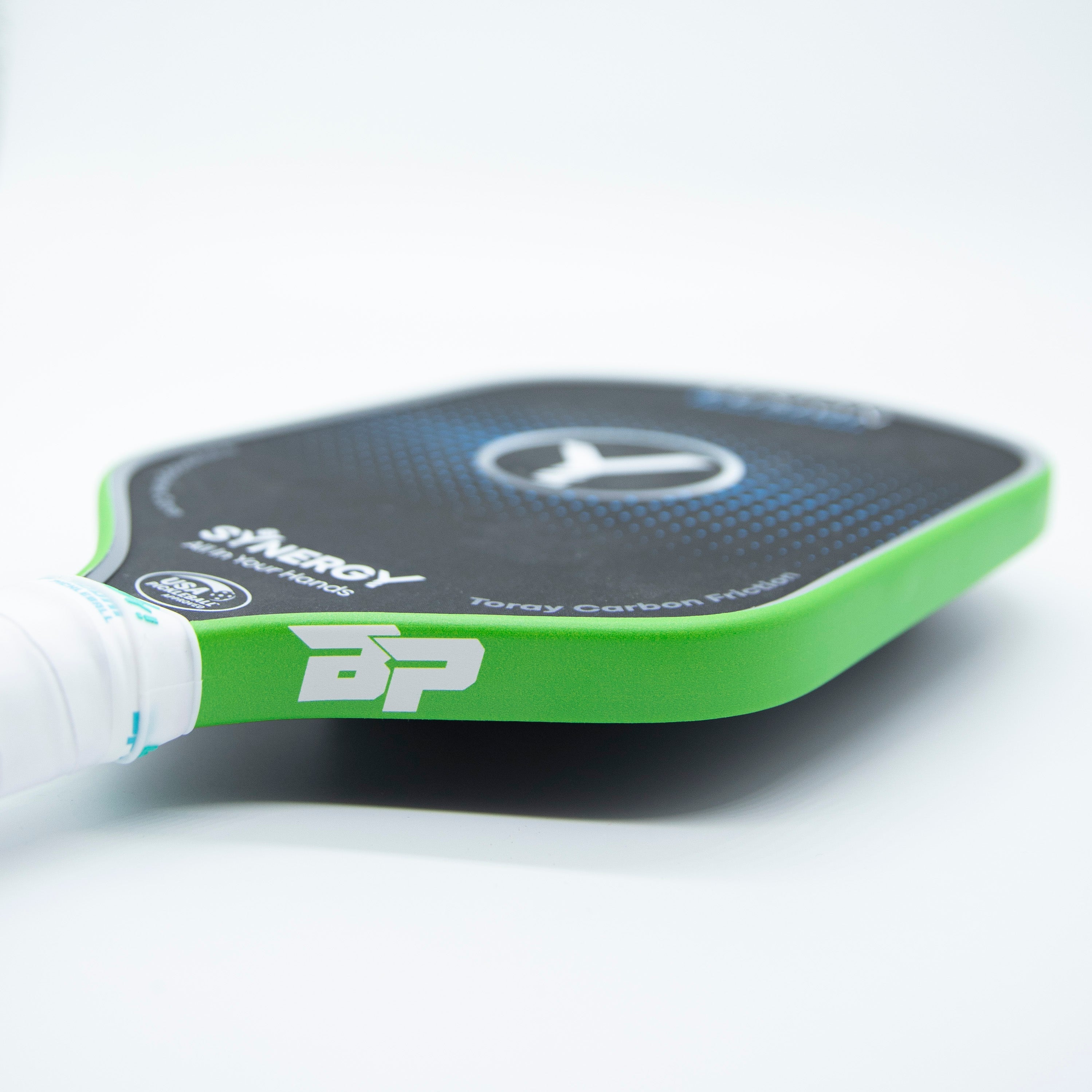 Green pickleball paddle edge tape by DinkersAlley.com, accenting a black paddle with a white handle and visible text.