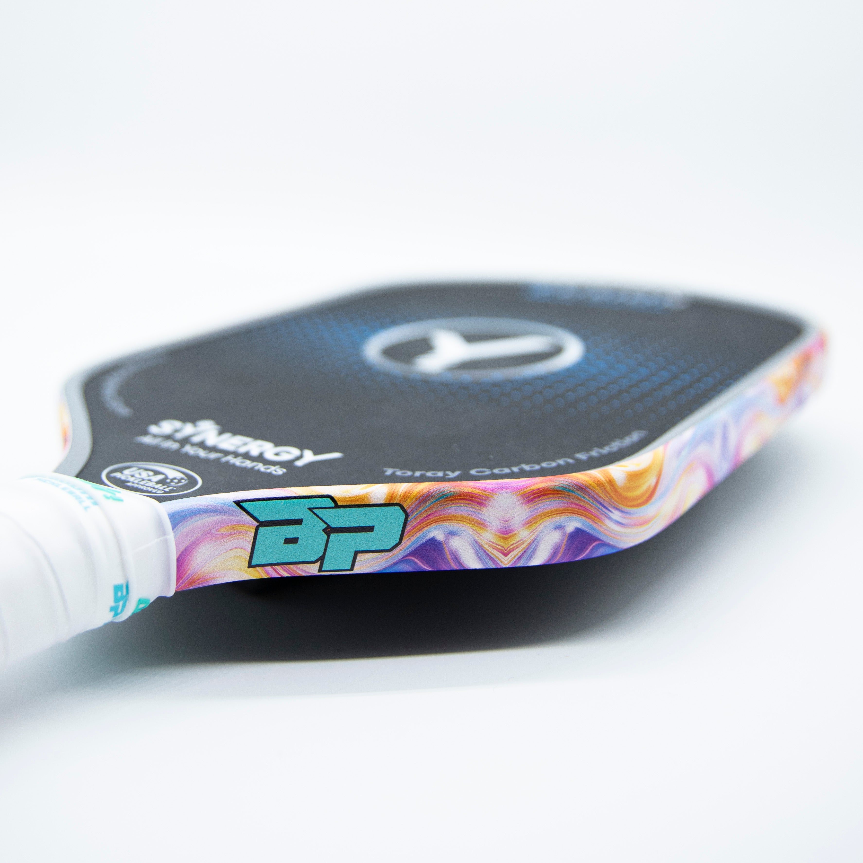 Close-up of a colorful pickleball paddle.
