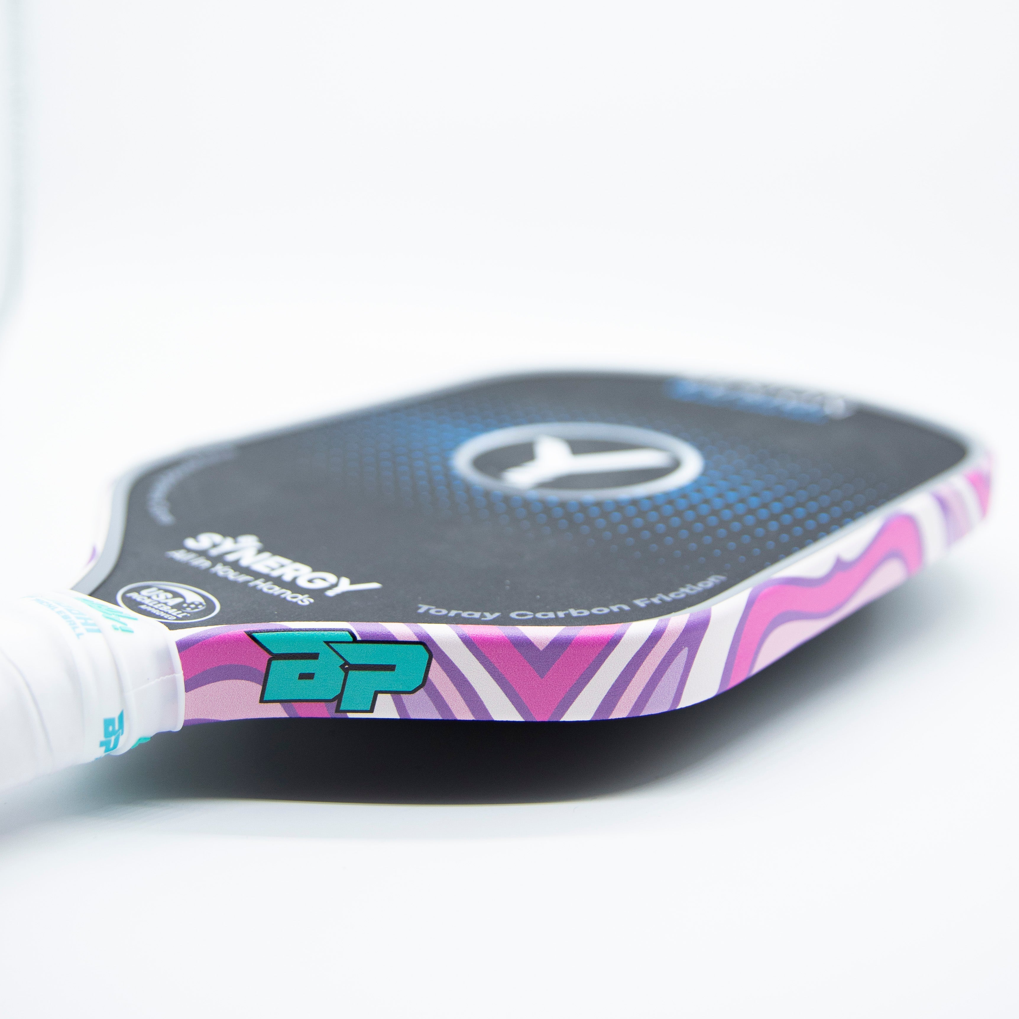 Close-up of a pickleball paddle with pink and purple stripes.