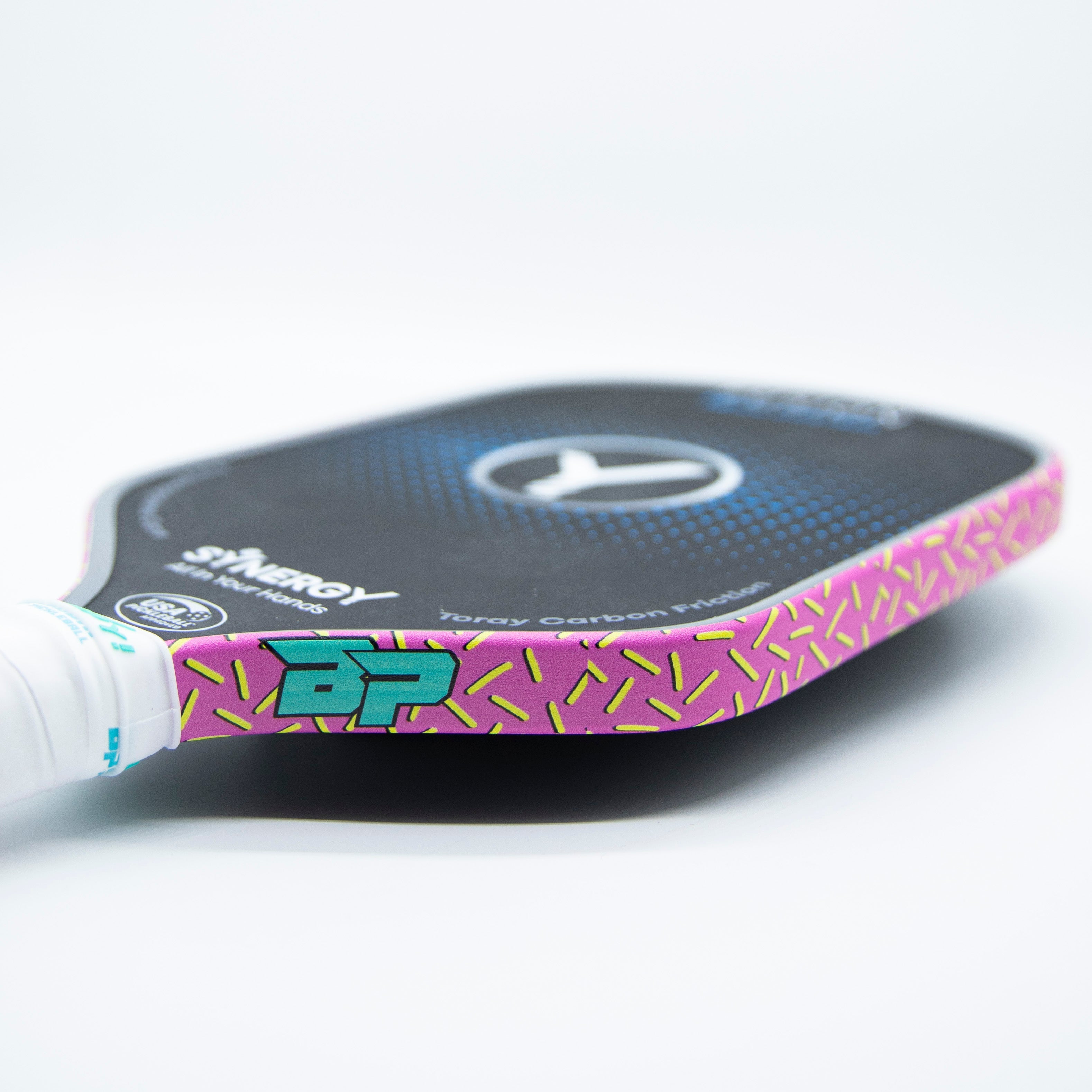Pickleball paddle with pink and lime green design.