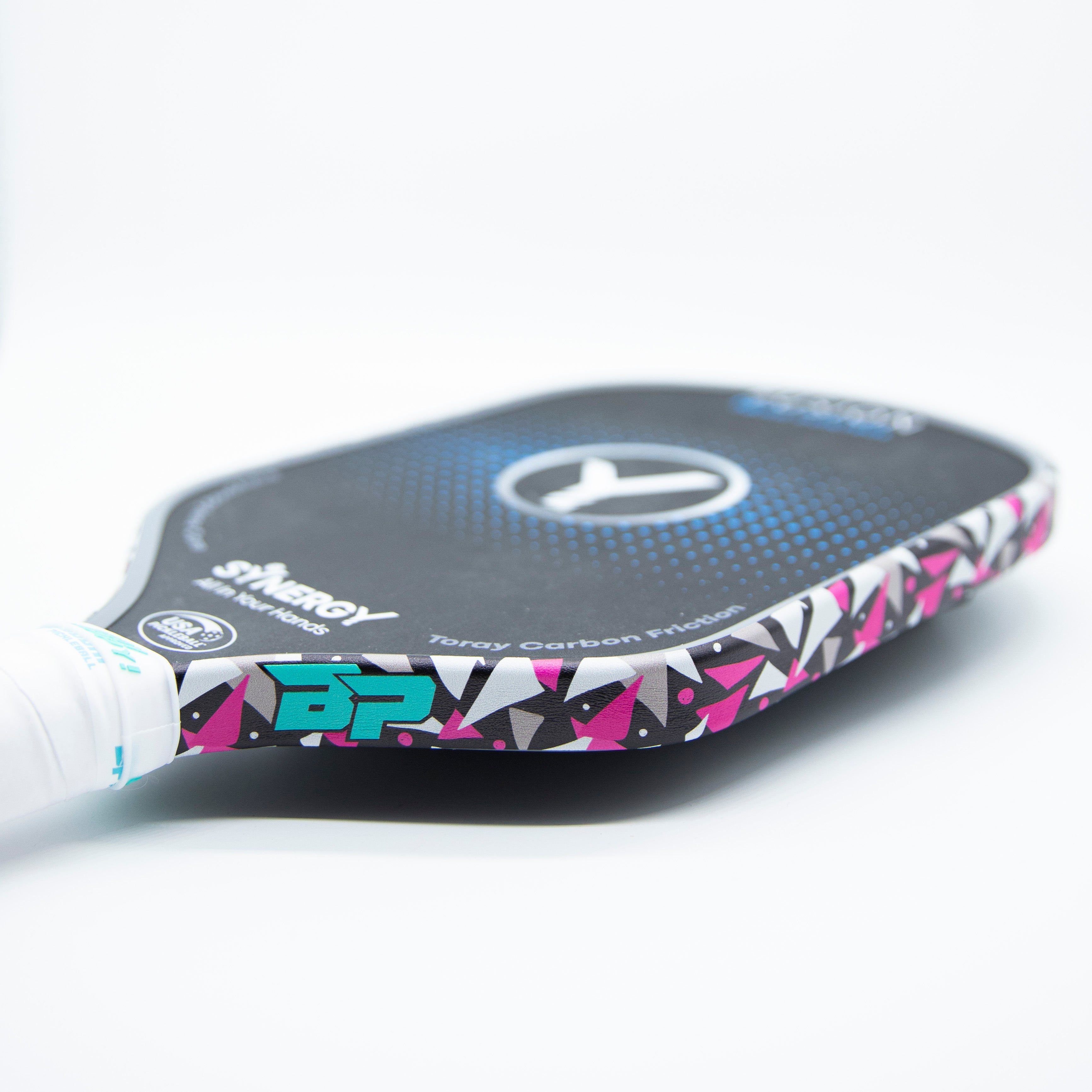 Close-up of a pink and black pickleball paddle.
