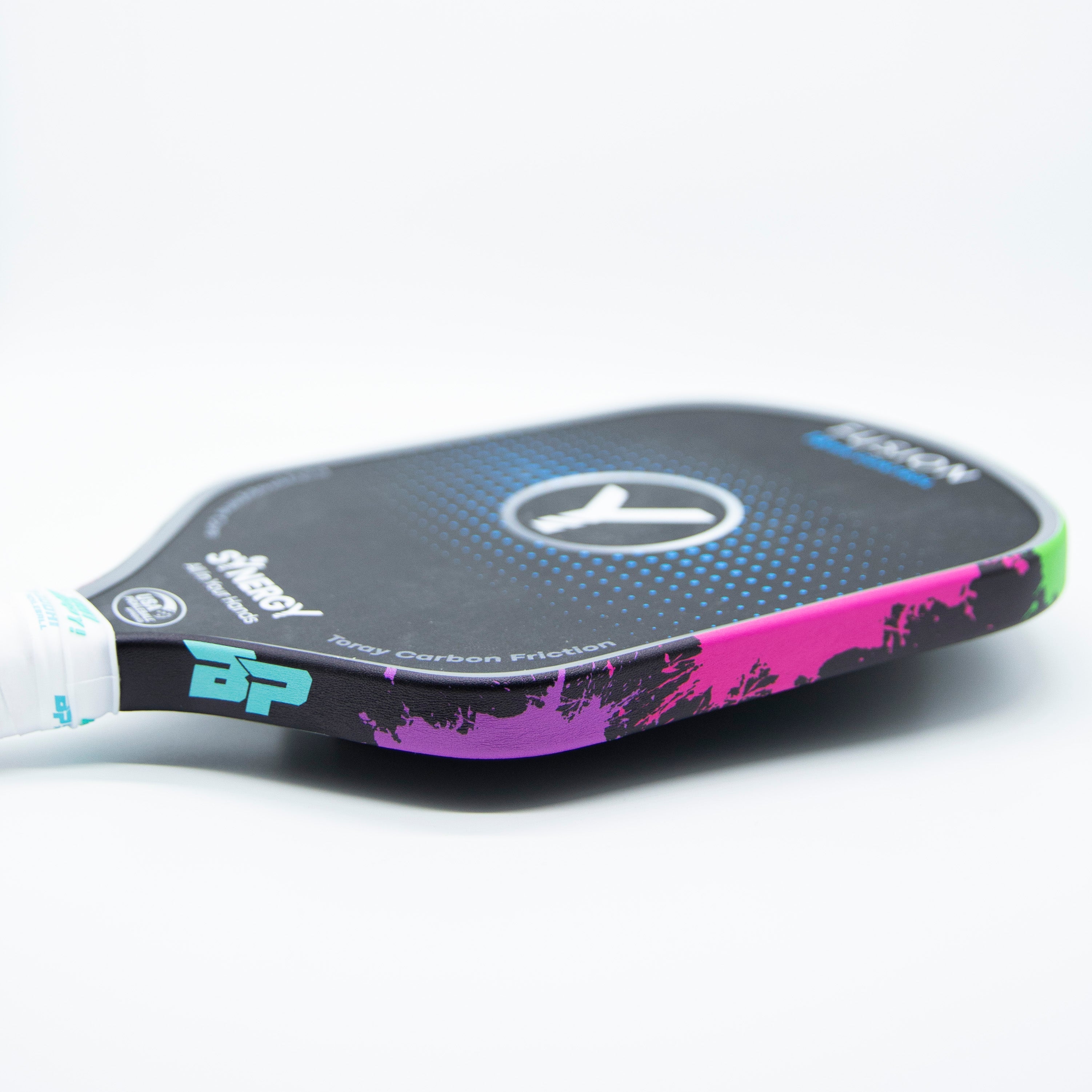 Pickleball paddle with colorful, splattered edges.