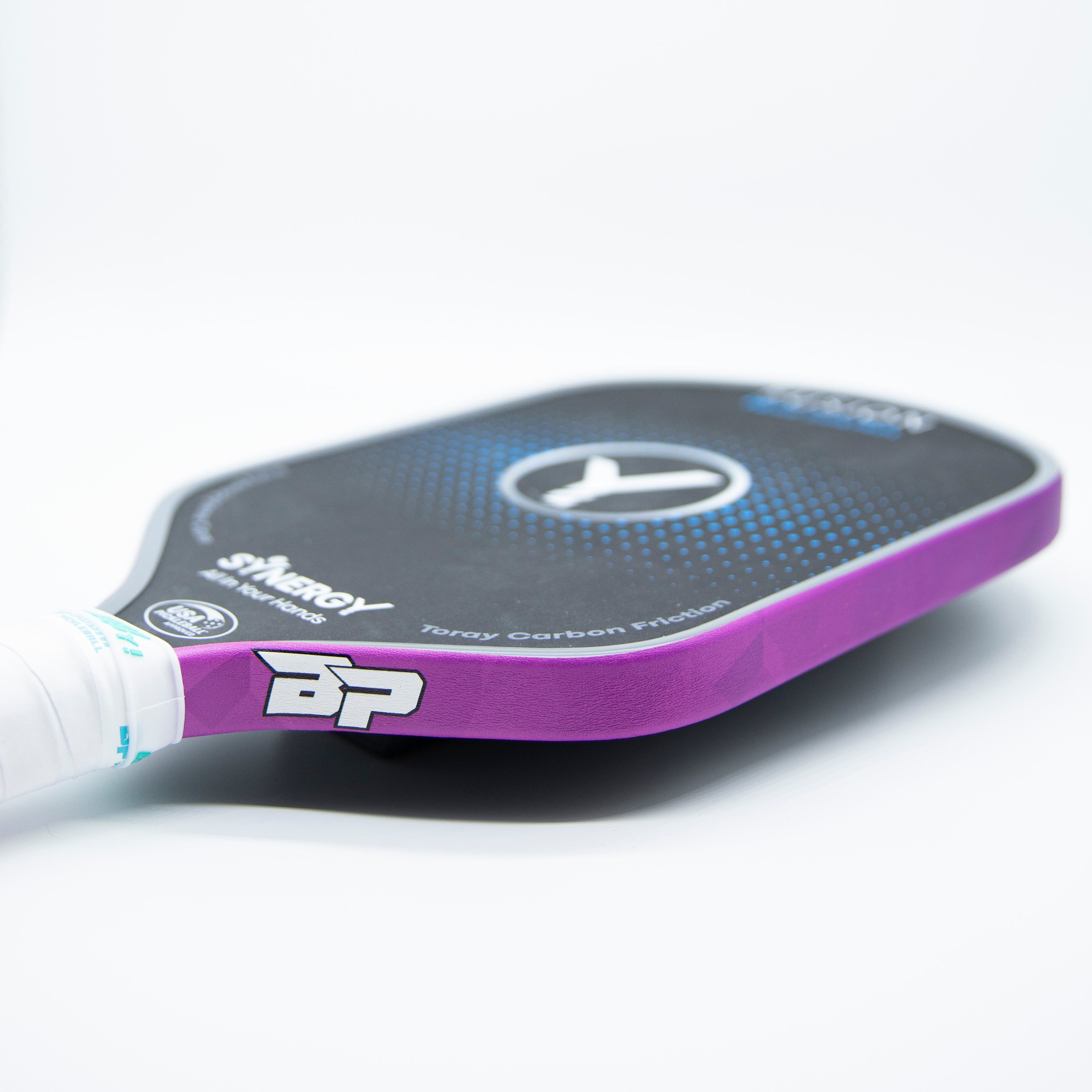 Purple and black Synergy pickleball paddle with white grip.