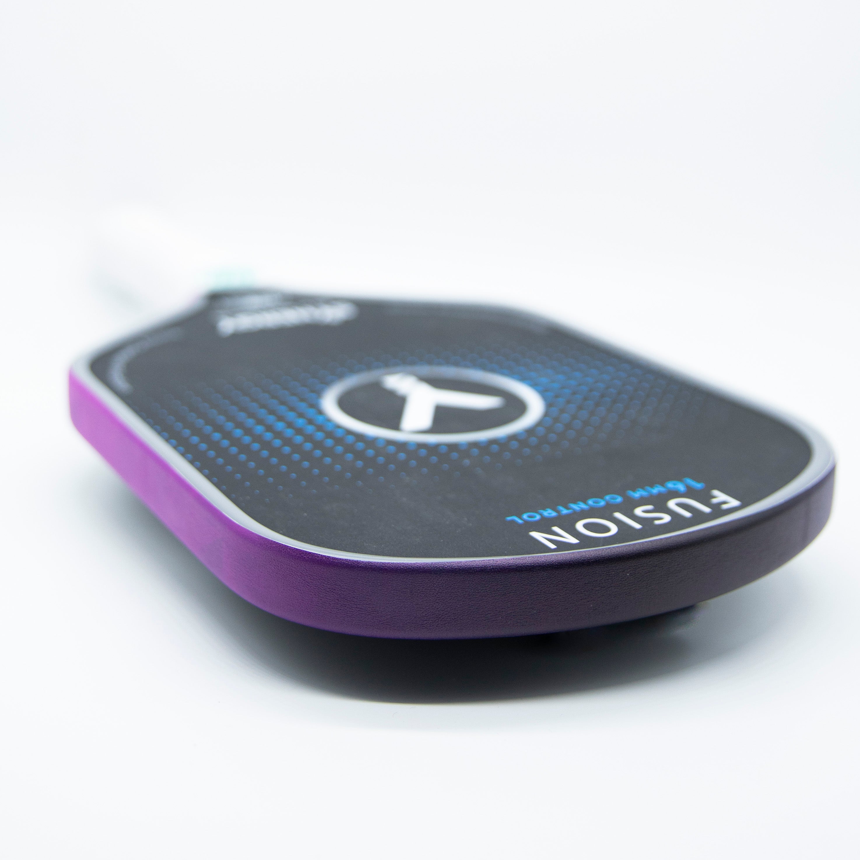 Close-up of a purple and black pickleball paddle.
