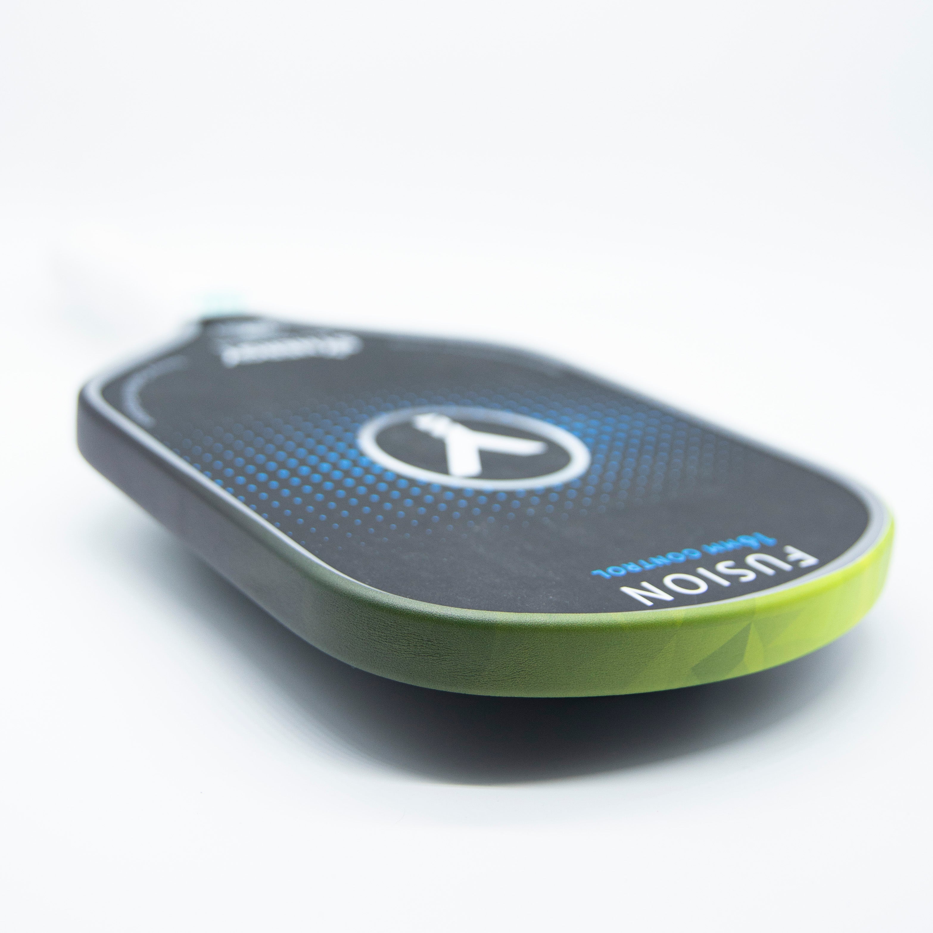 Close-up of a pickleball paddle with a green and black edge.