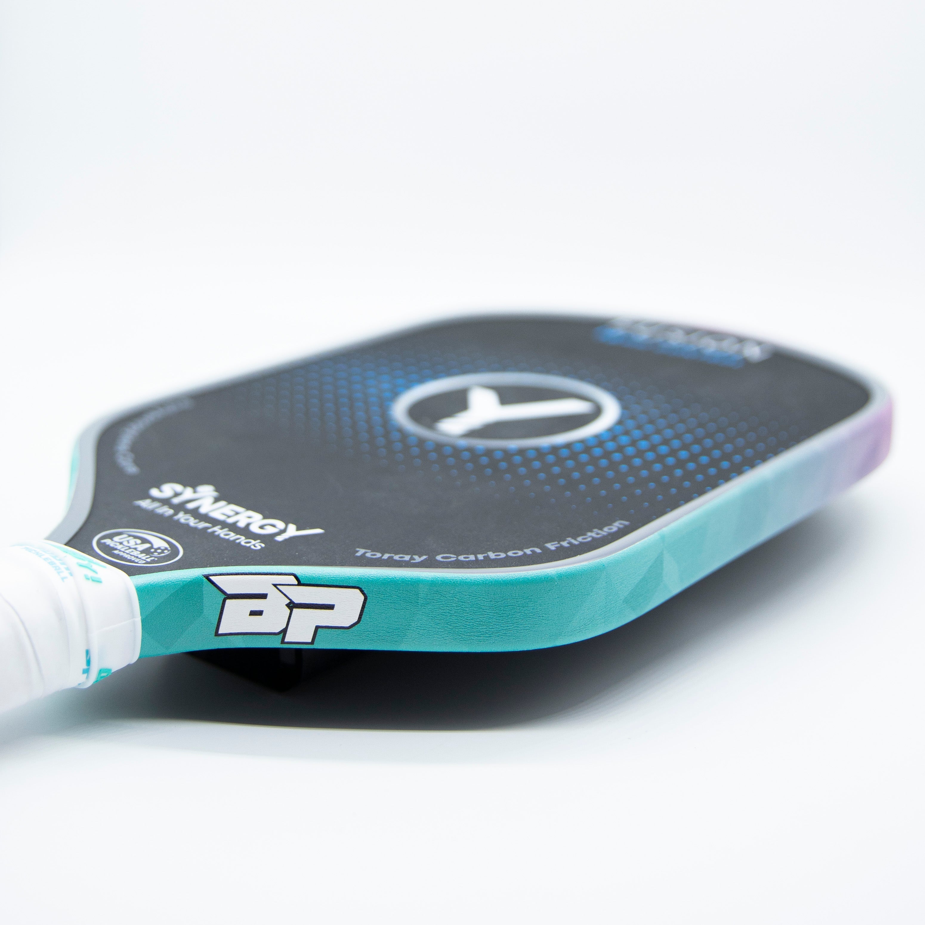 Close-up of a turquoise and black pickleball paddle.