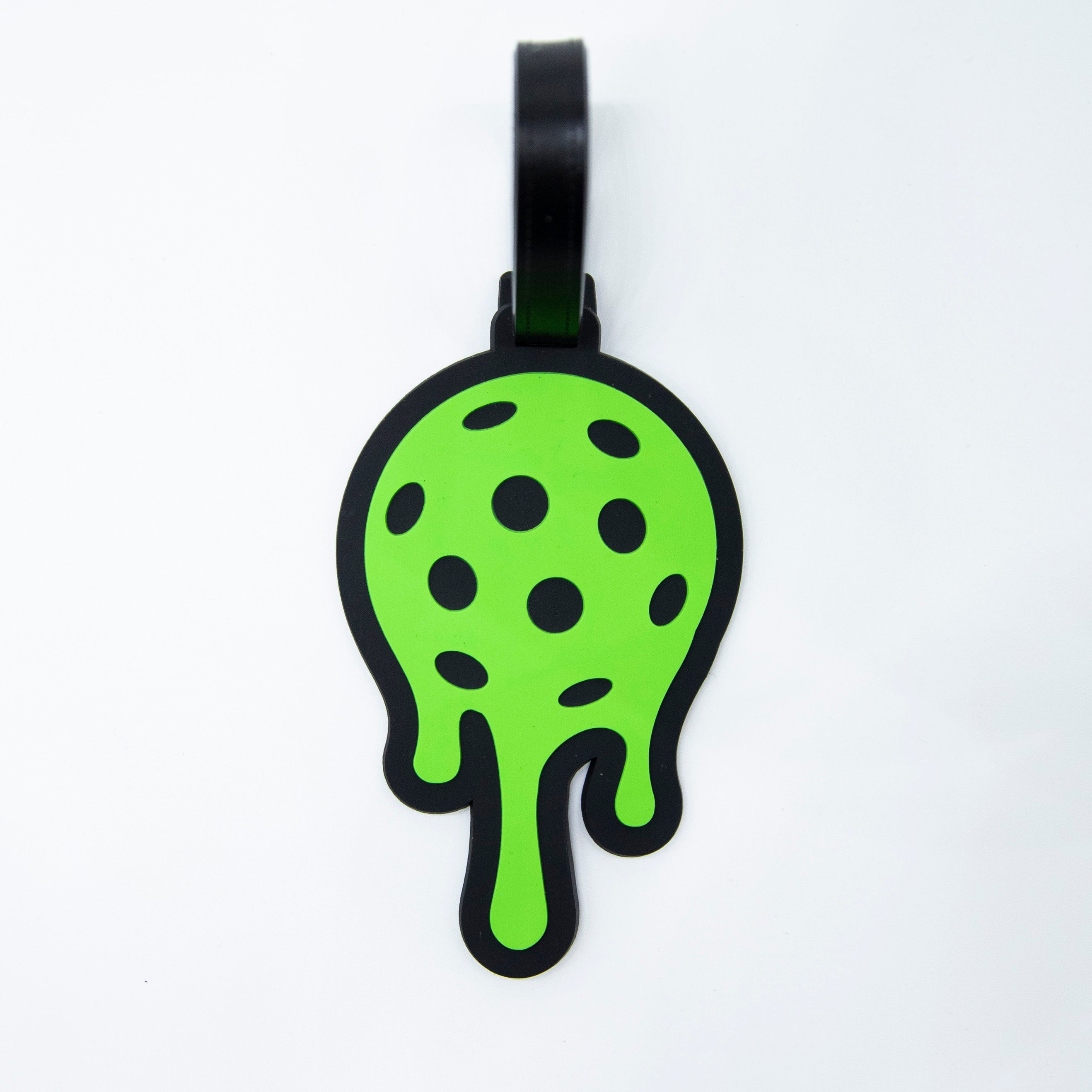 Green, dripping, pickleball bag tag with black loop.