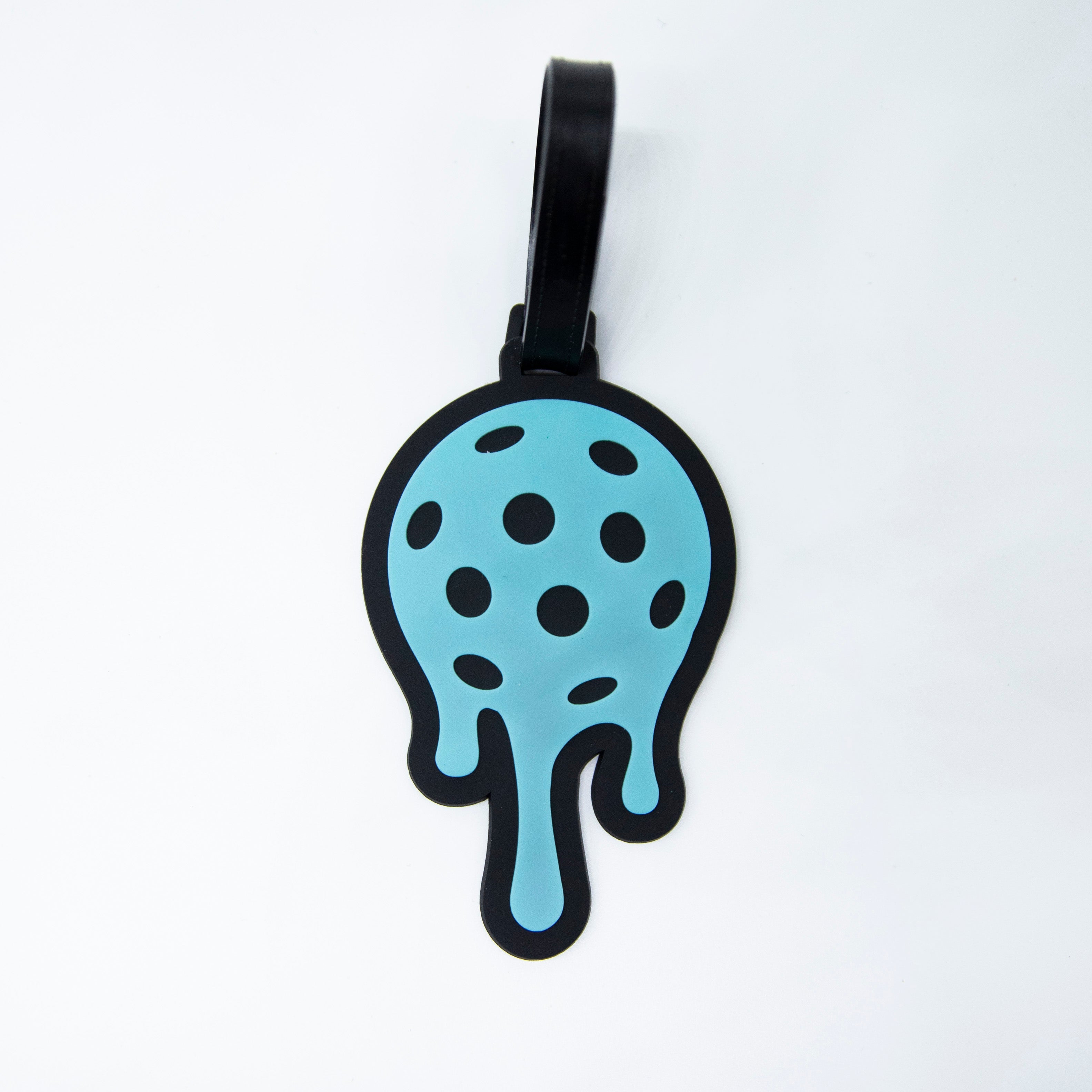 Blue and black novelty luggage tag shaped like a melting pickleball.