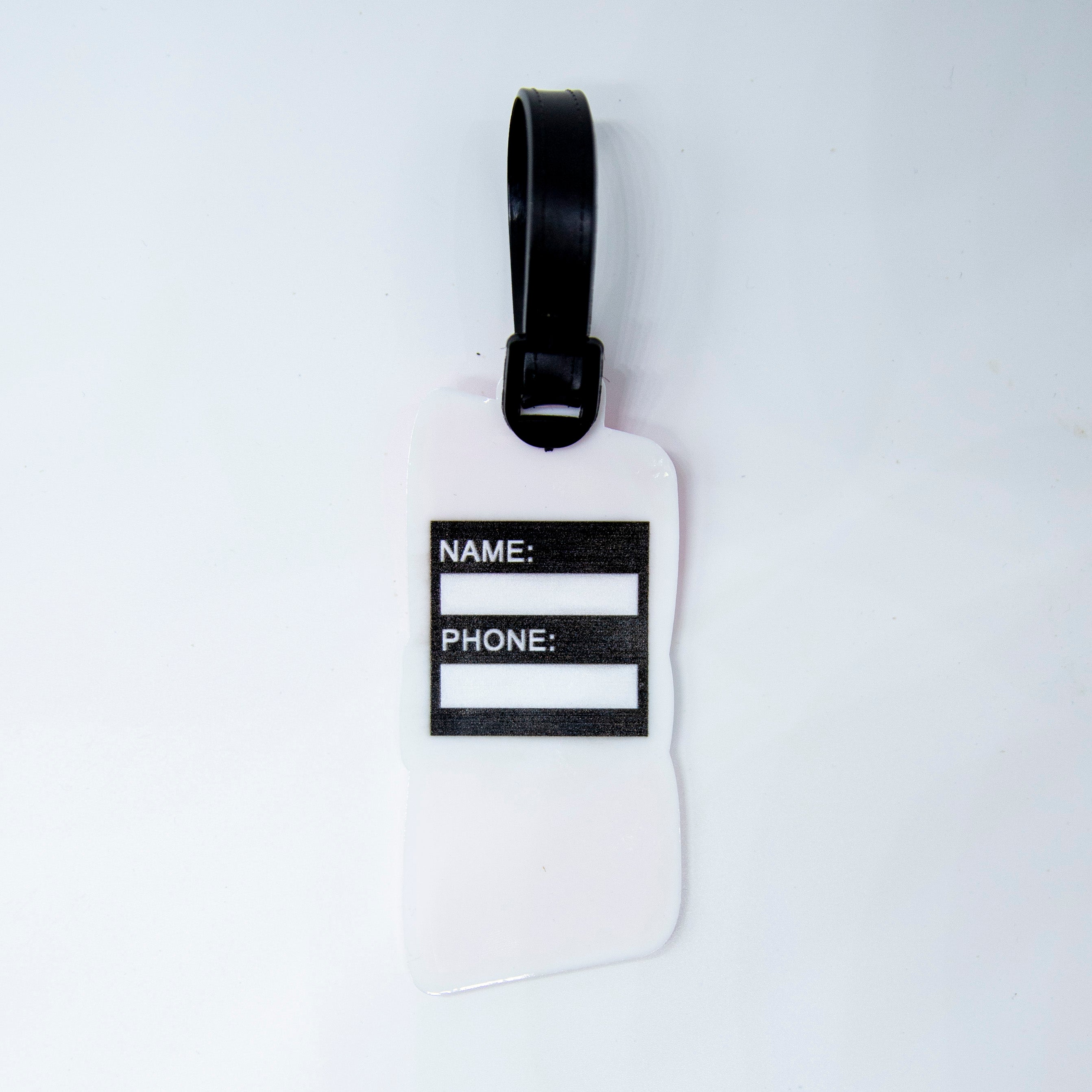 White luggage tag with black strap.