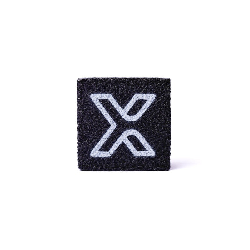 Black cube with white X-shaped design.