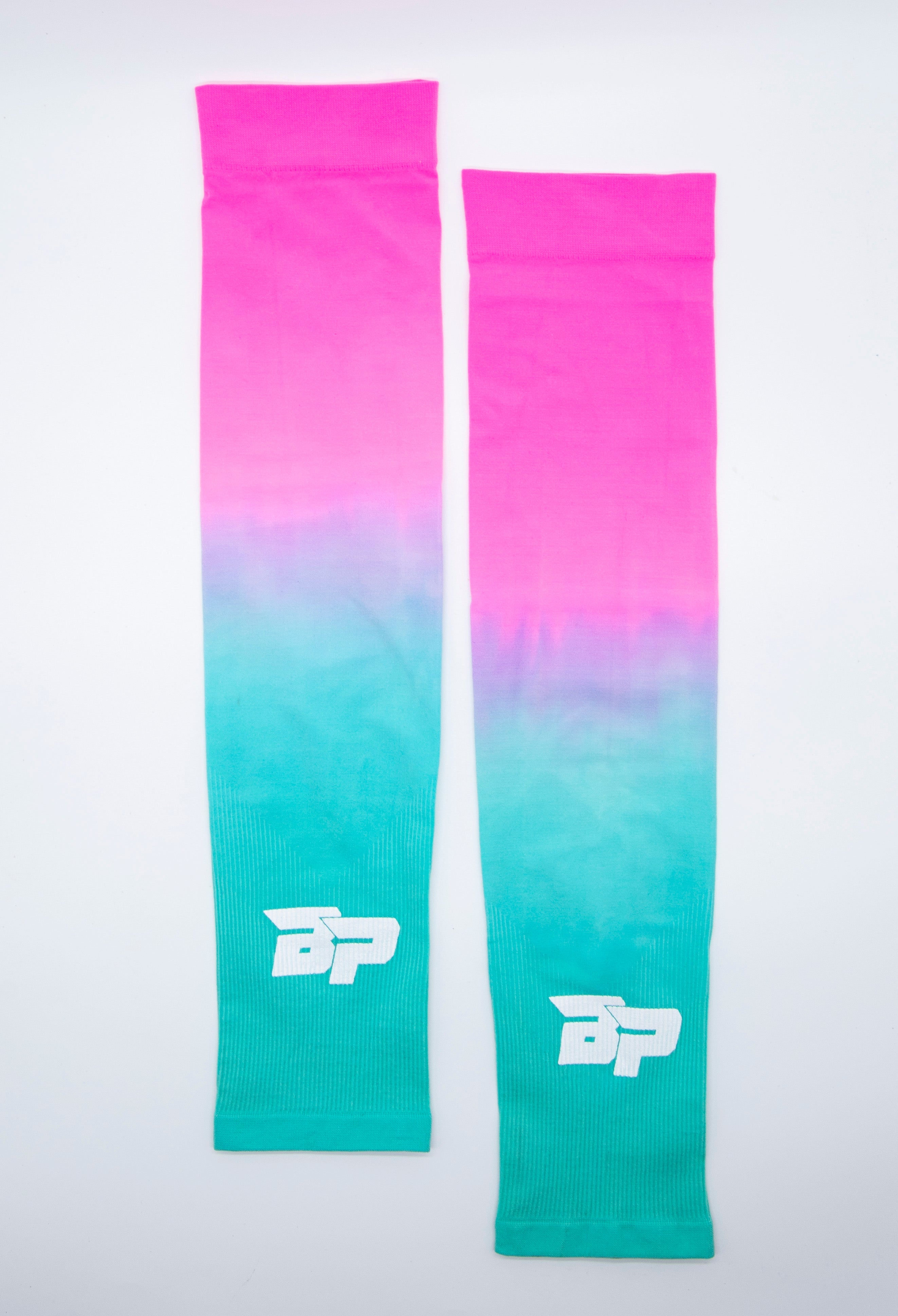 Two gradient pink to teal arm sleeves by Bodhi Pickleball, with white 'BP' logo and ribbed cuffs, displayed side by side.
