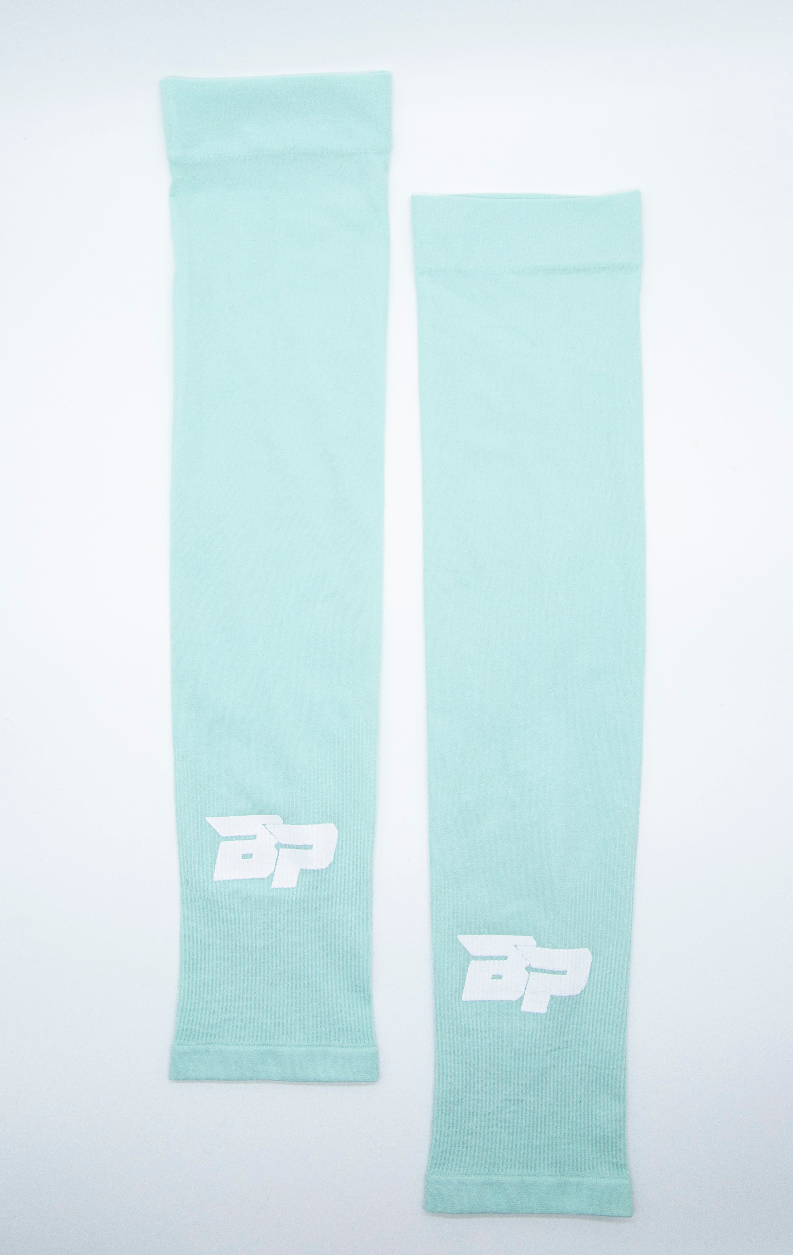 Two aqua blue compression sleeves with a white logo on a white background.