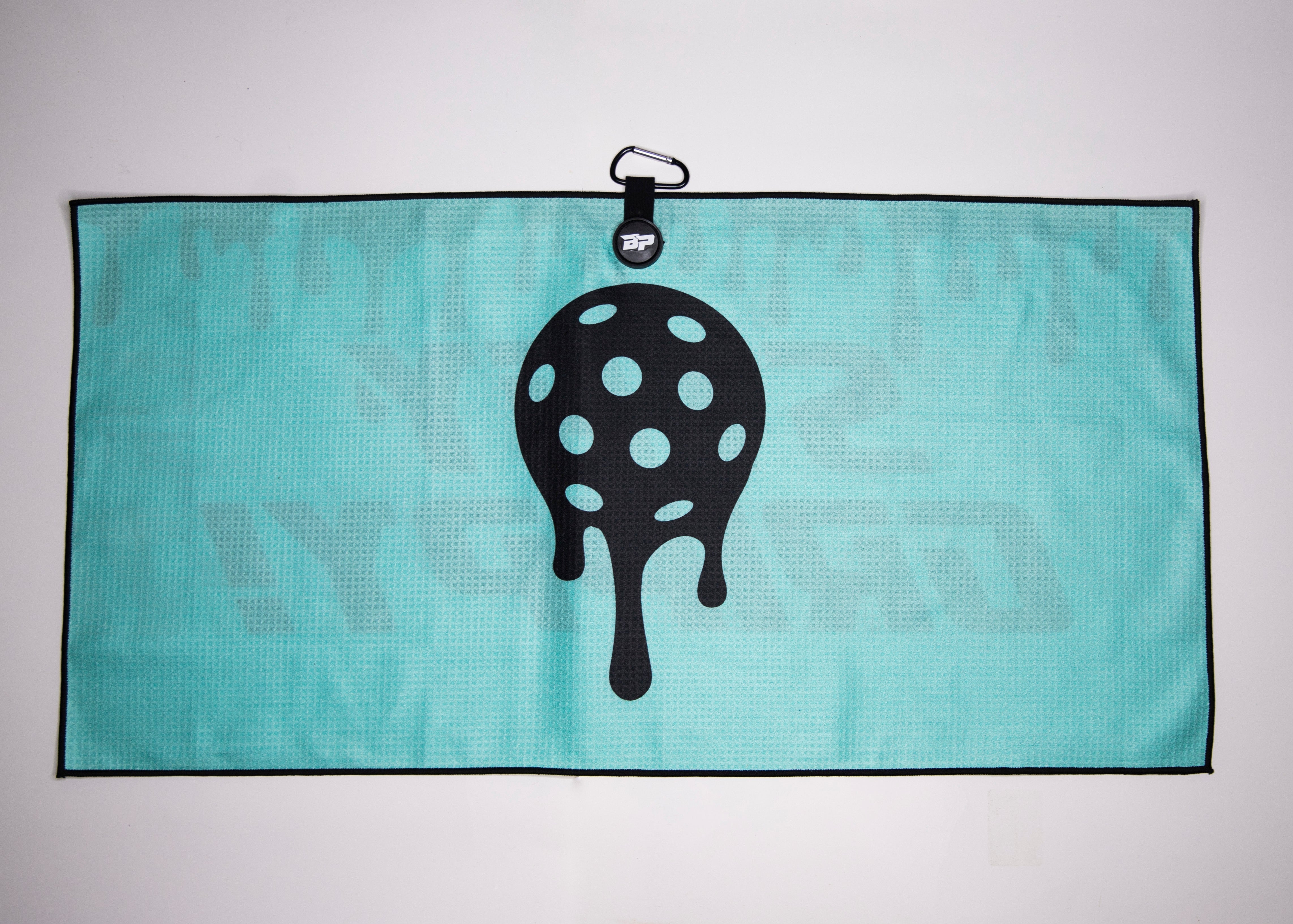 Aqua waffle-weave towel with black trim and dripping black pickleball design.
