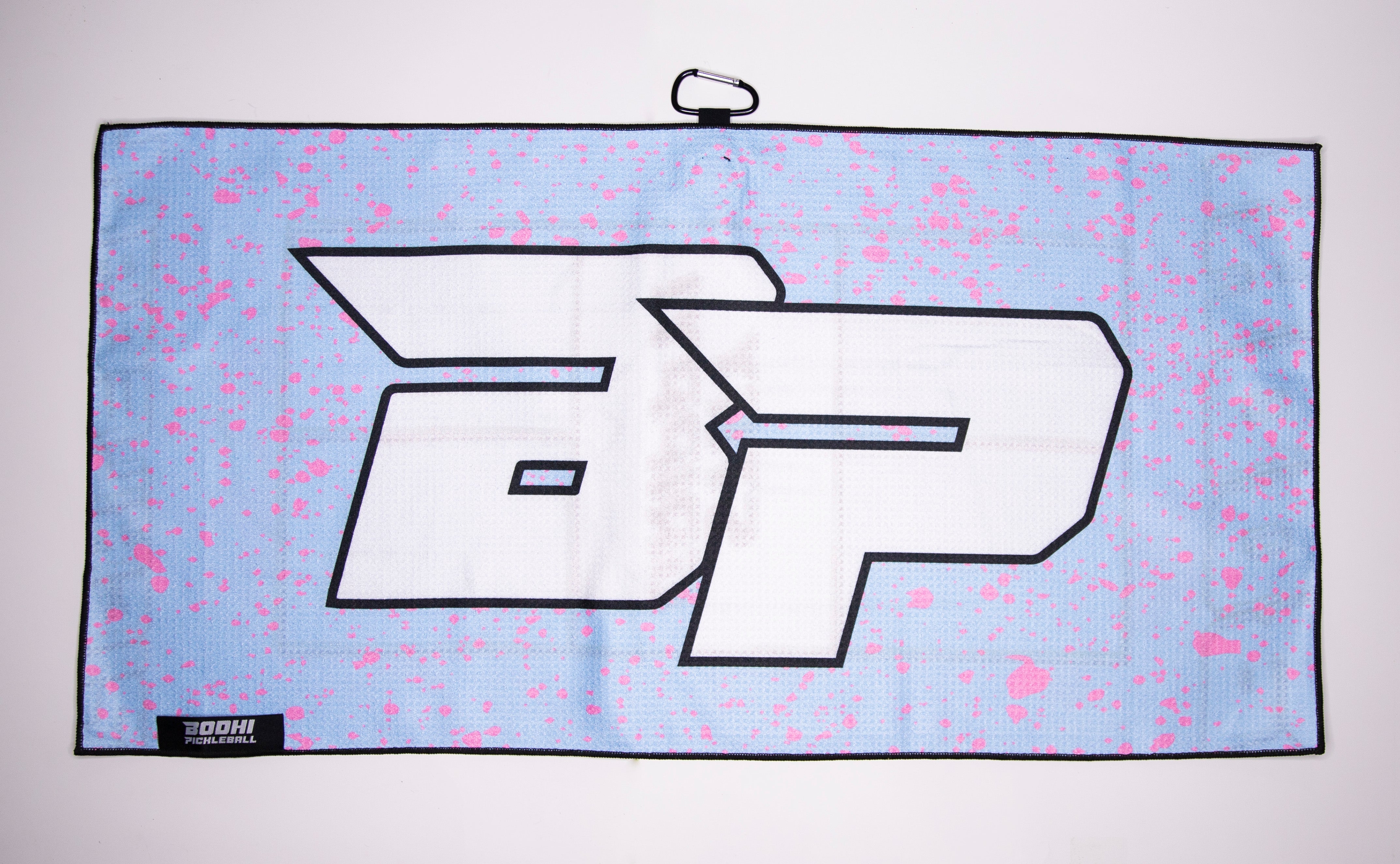 Blue and pink pickleball towel with a white "BP" logo and black border.
