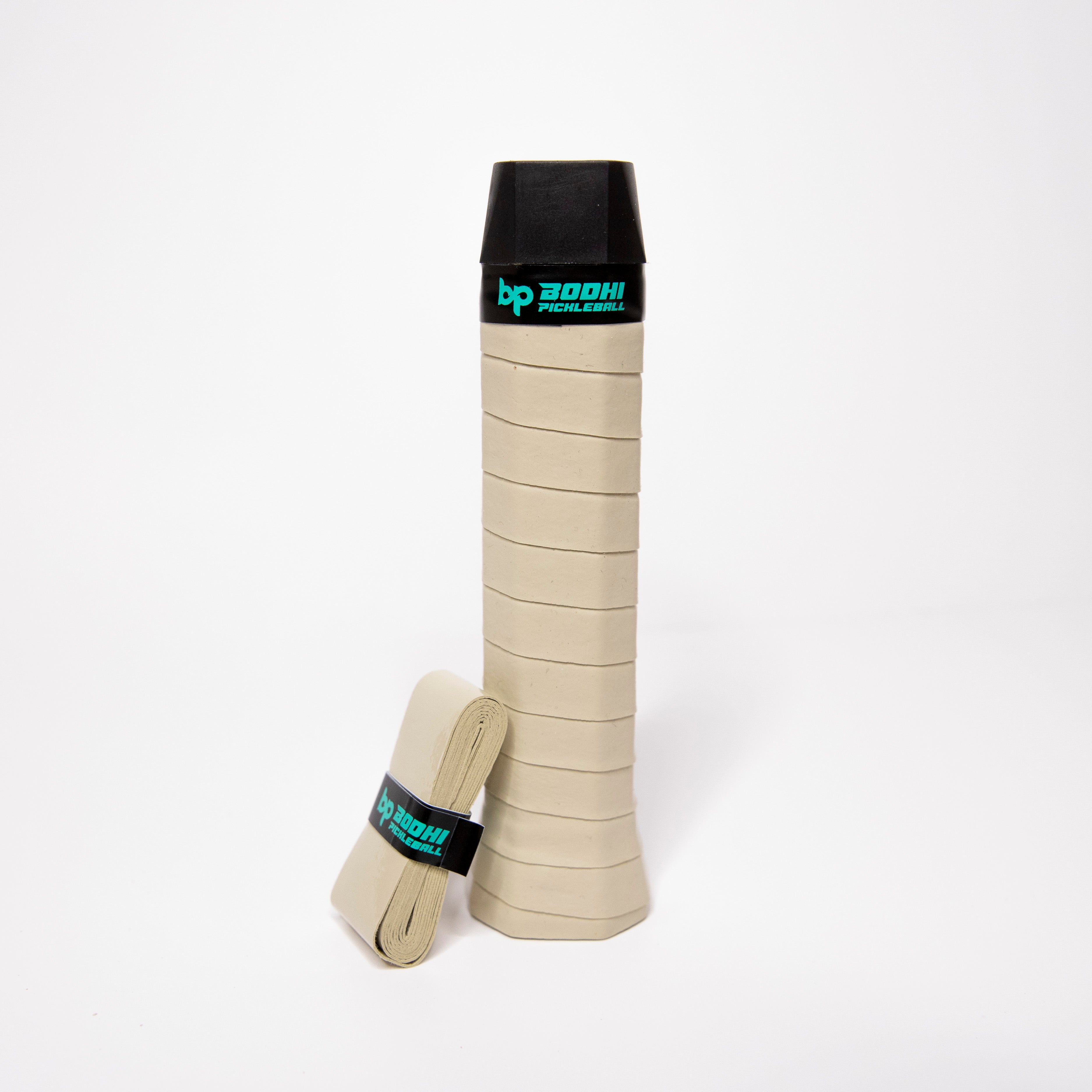 Pickleball paddle grip with a second roll. Beige with black trim.