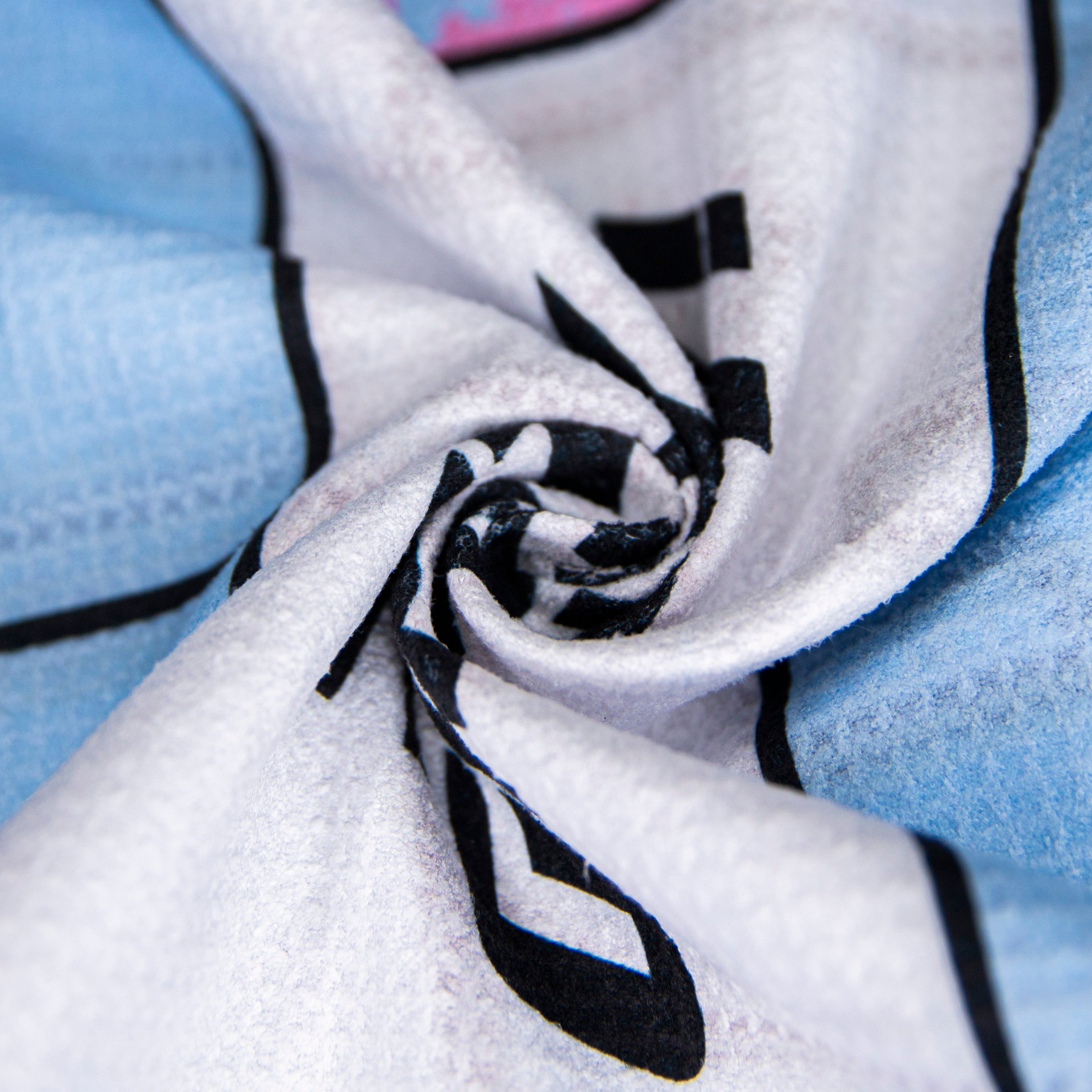 Close-up of a folded blue and white patterned fabric.