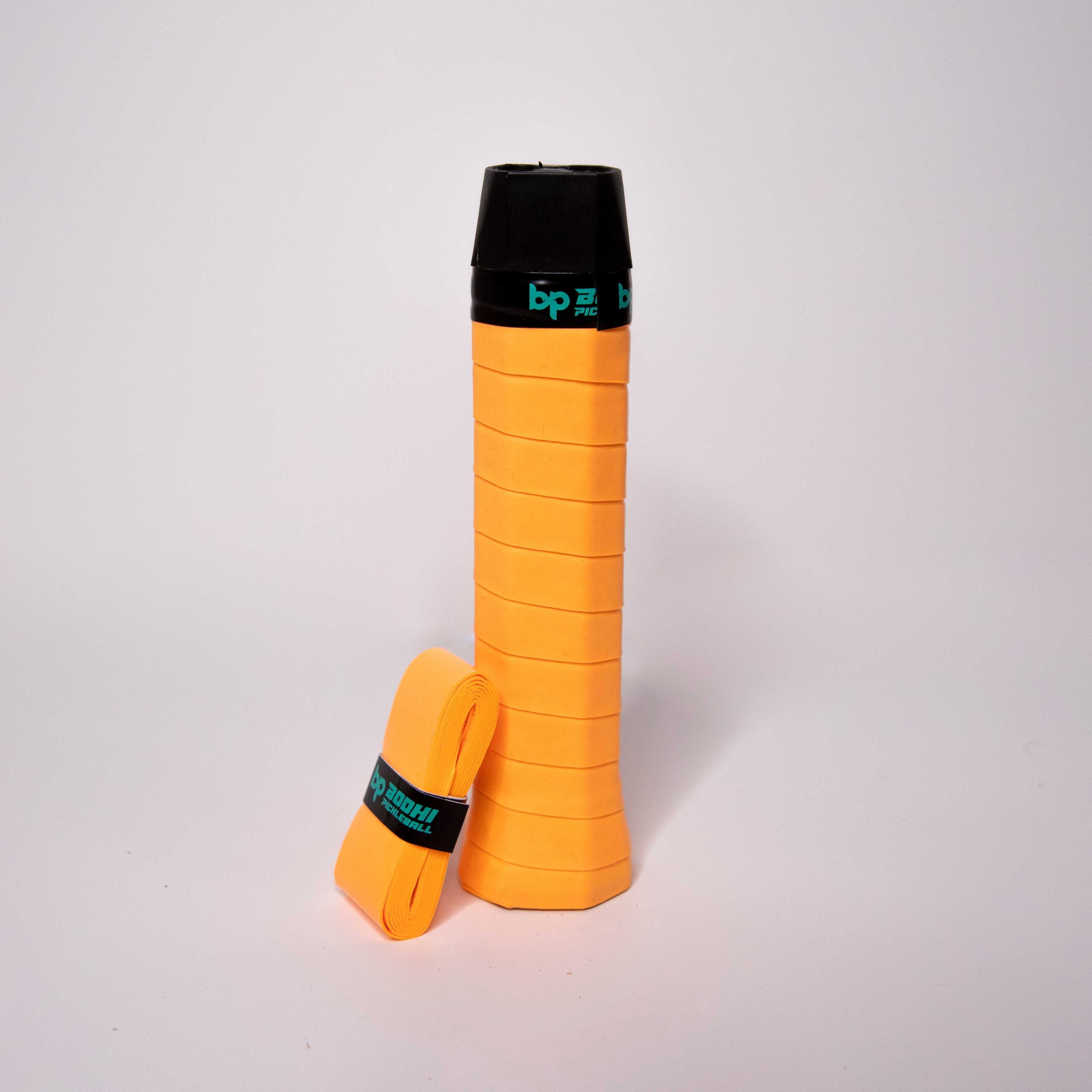 Orange pickleball paddle grip and replacement grip.