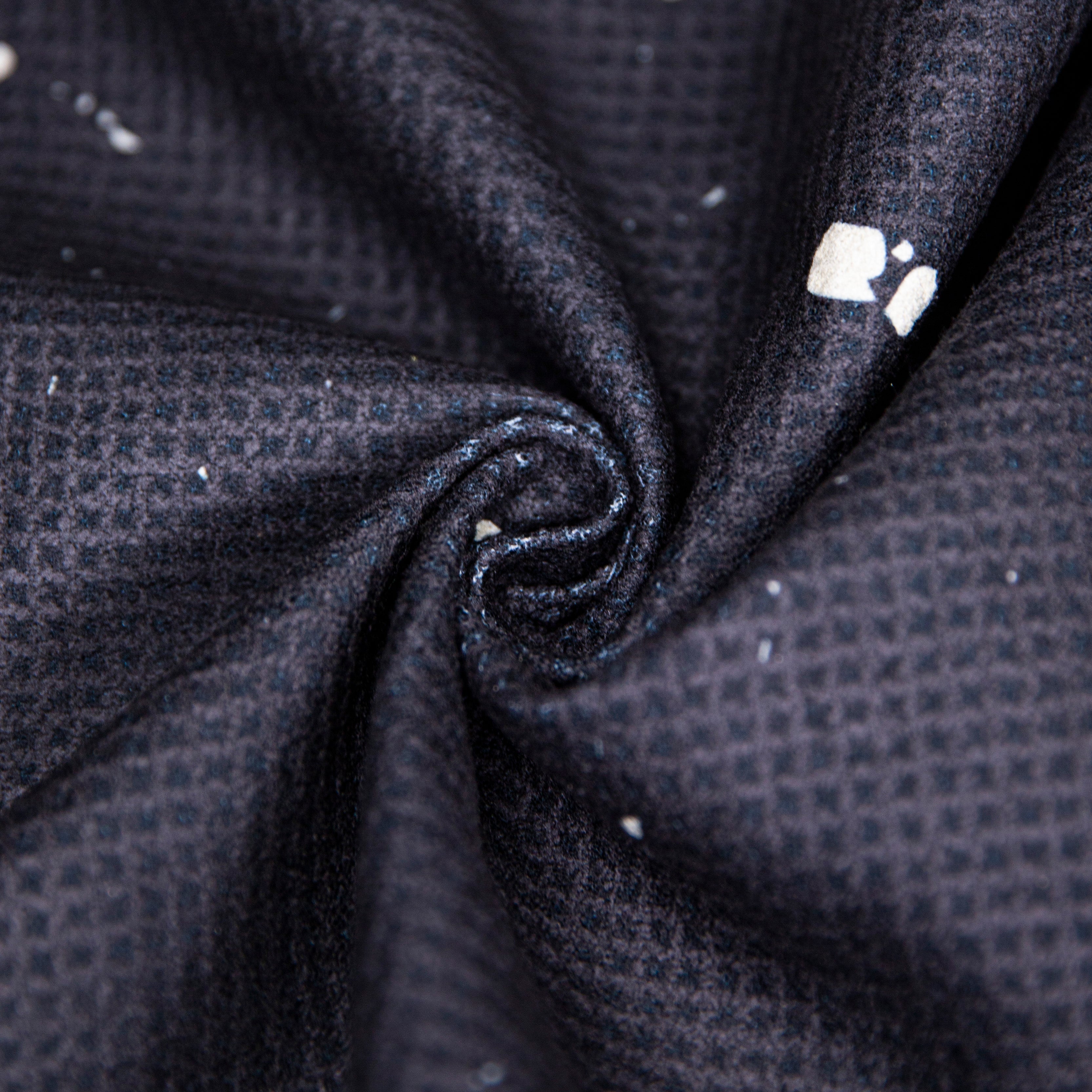 Swirled, dark textured fabric with white accents.