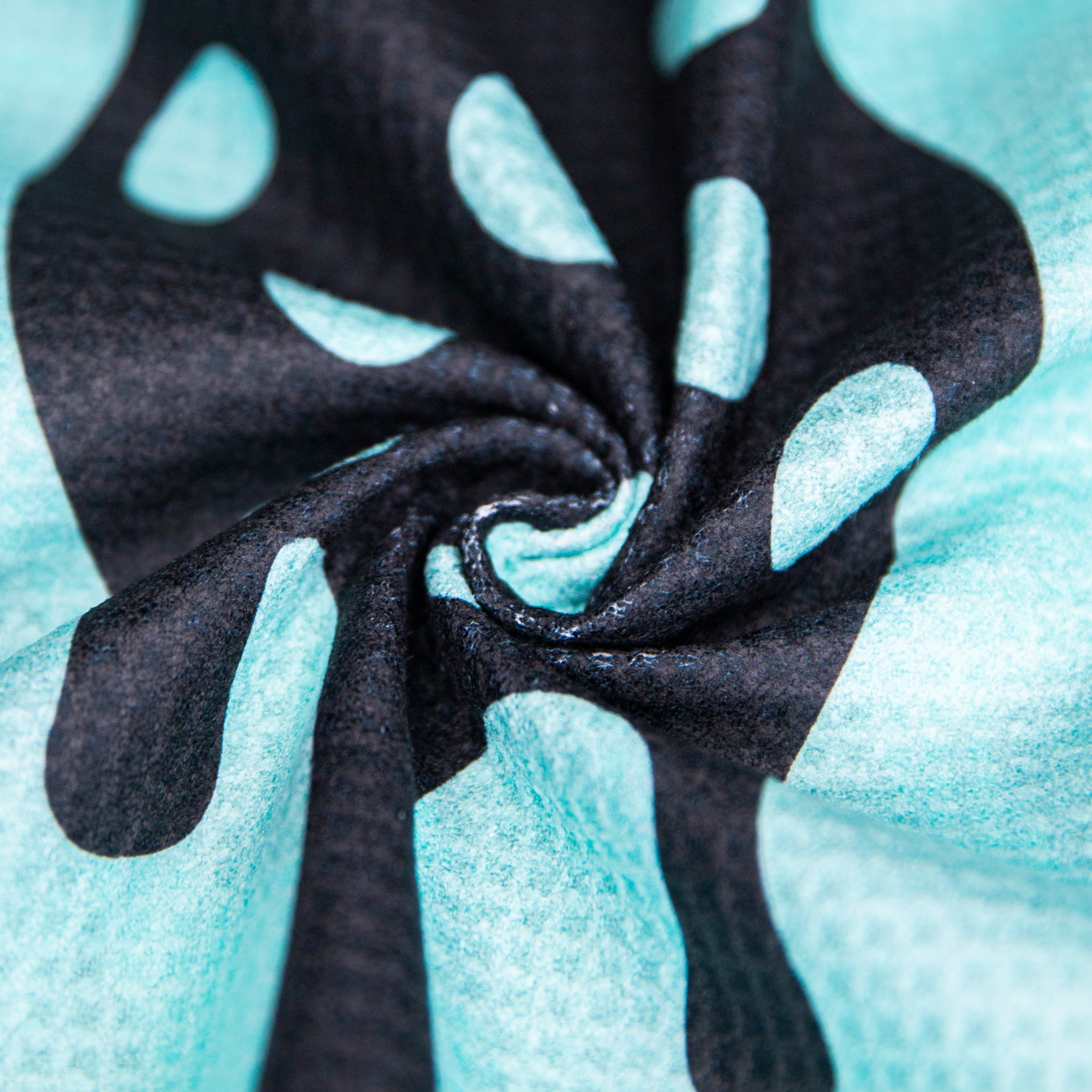 Close-up of a blue and black patterned fabric with a curled center.