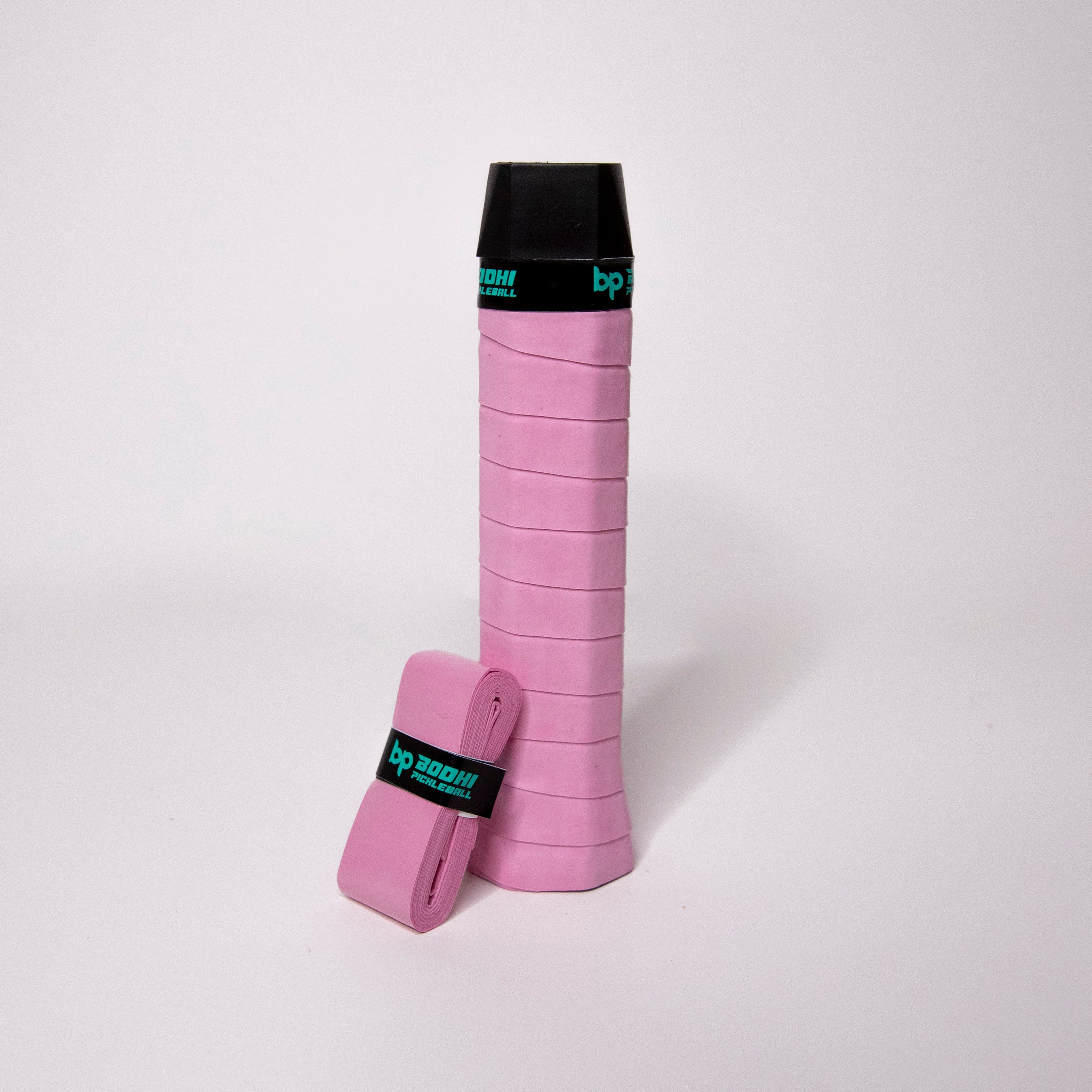 Pink tennis racket grip with black cap and wrap.