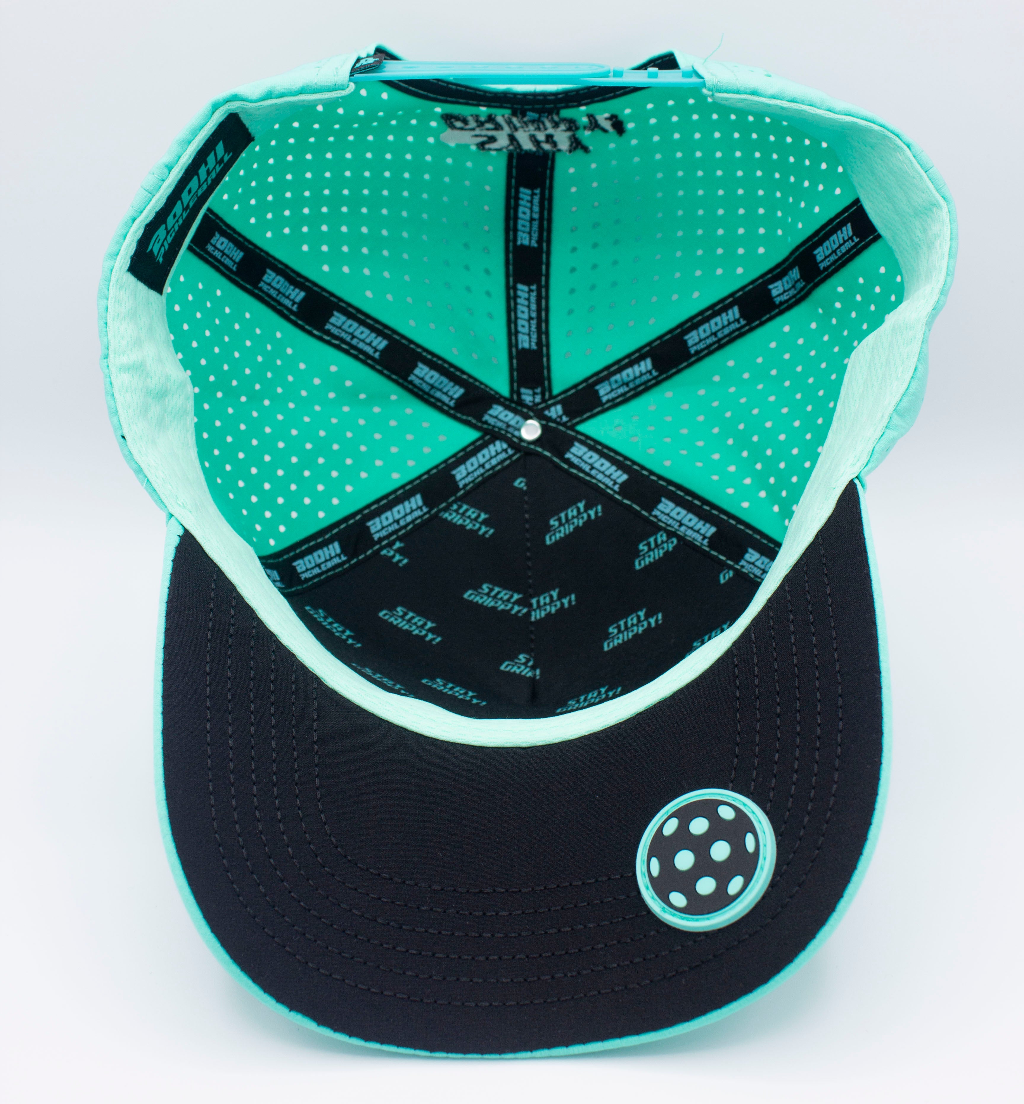 Close-up of an aqua and black baseball cap, viewed from the inside.