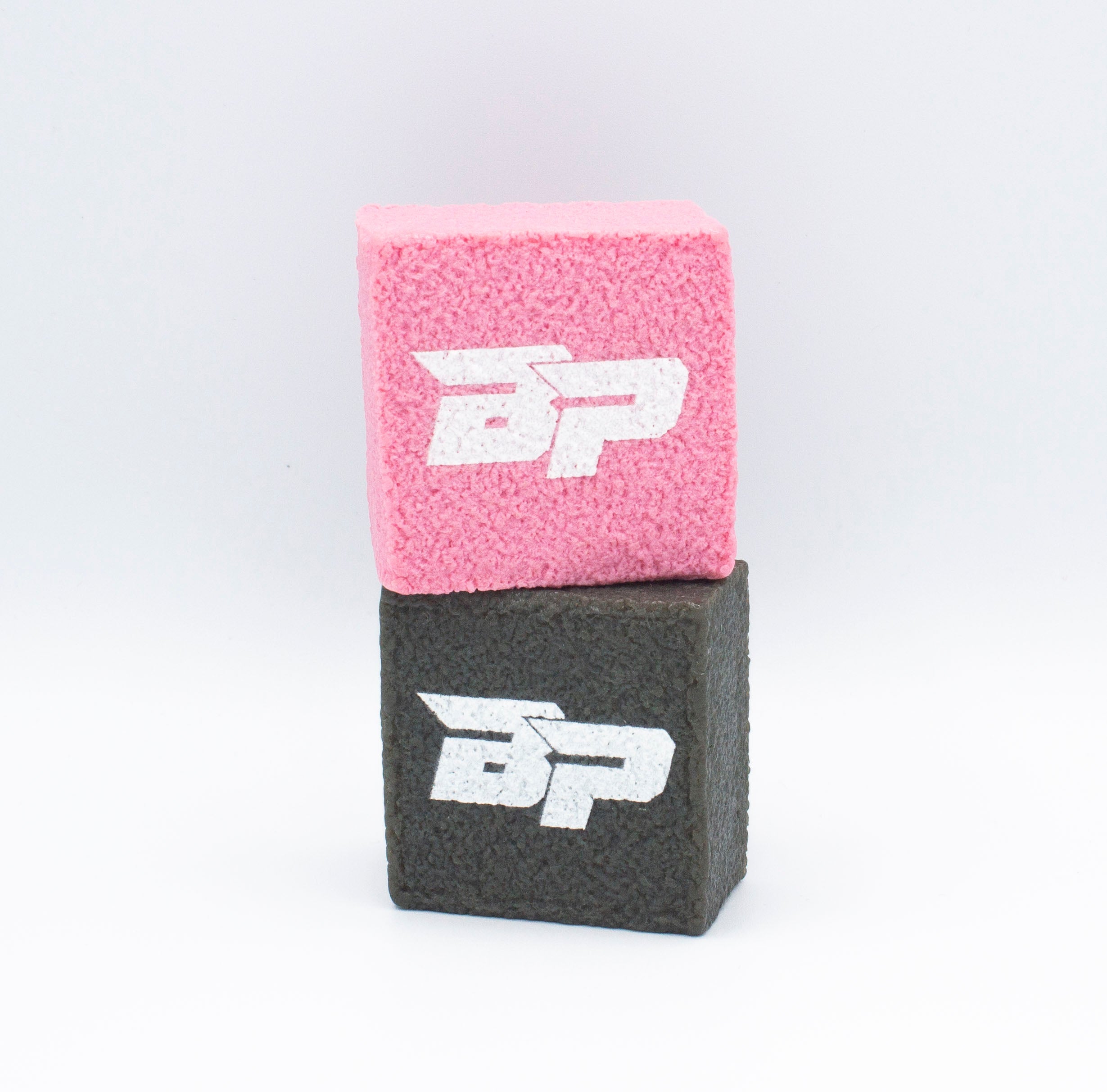 Two textured cubes stacked on top of each other. The top cube is pink and the bottom is gray. Both cubes have the same white "BP" logo on one side.