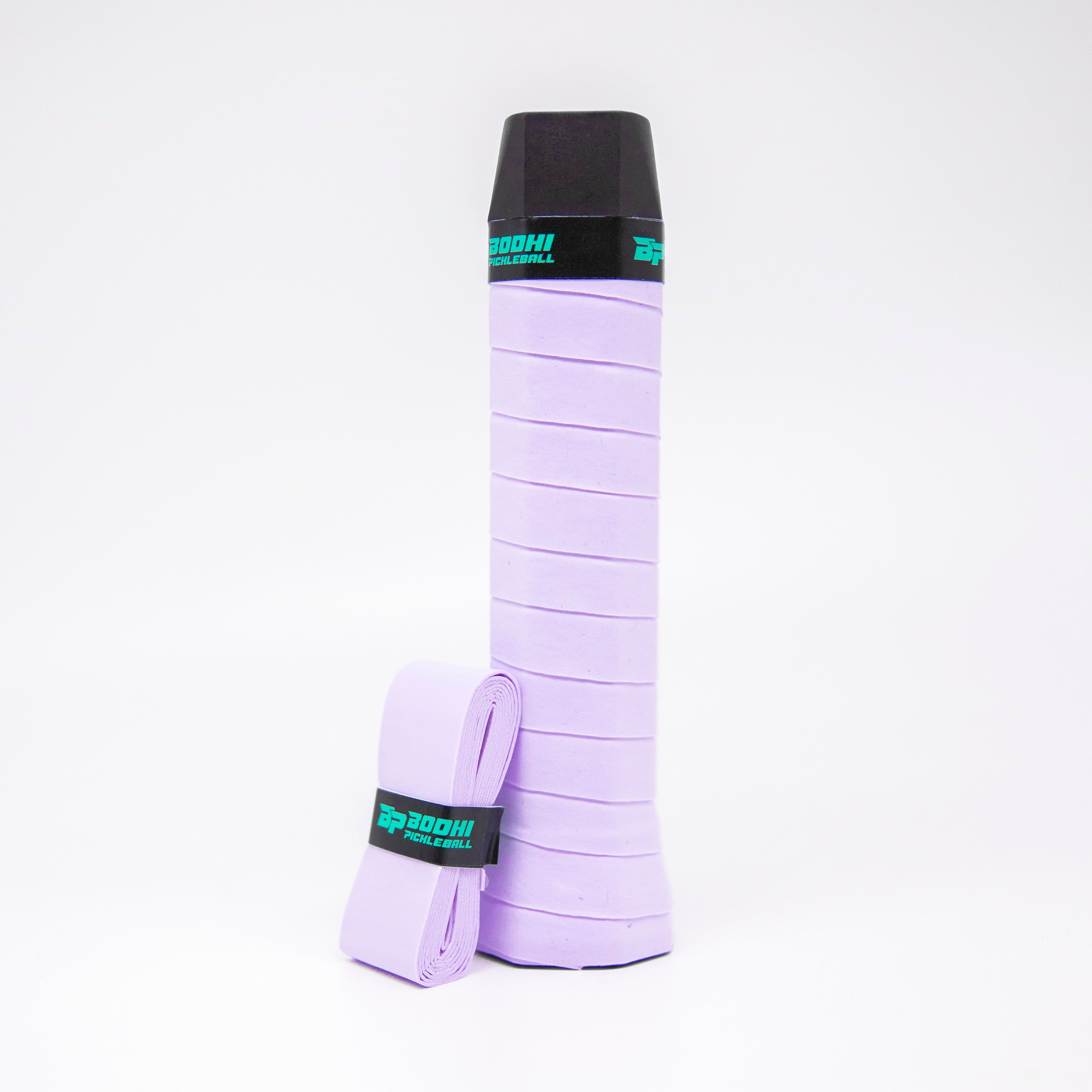 A light purple pickleball grip with a black cap and a teal logo.