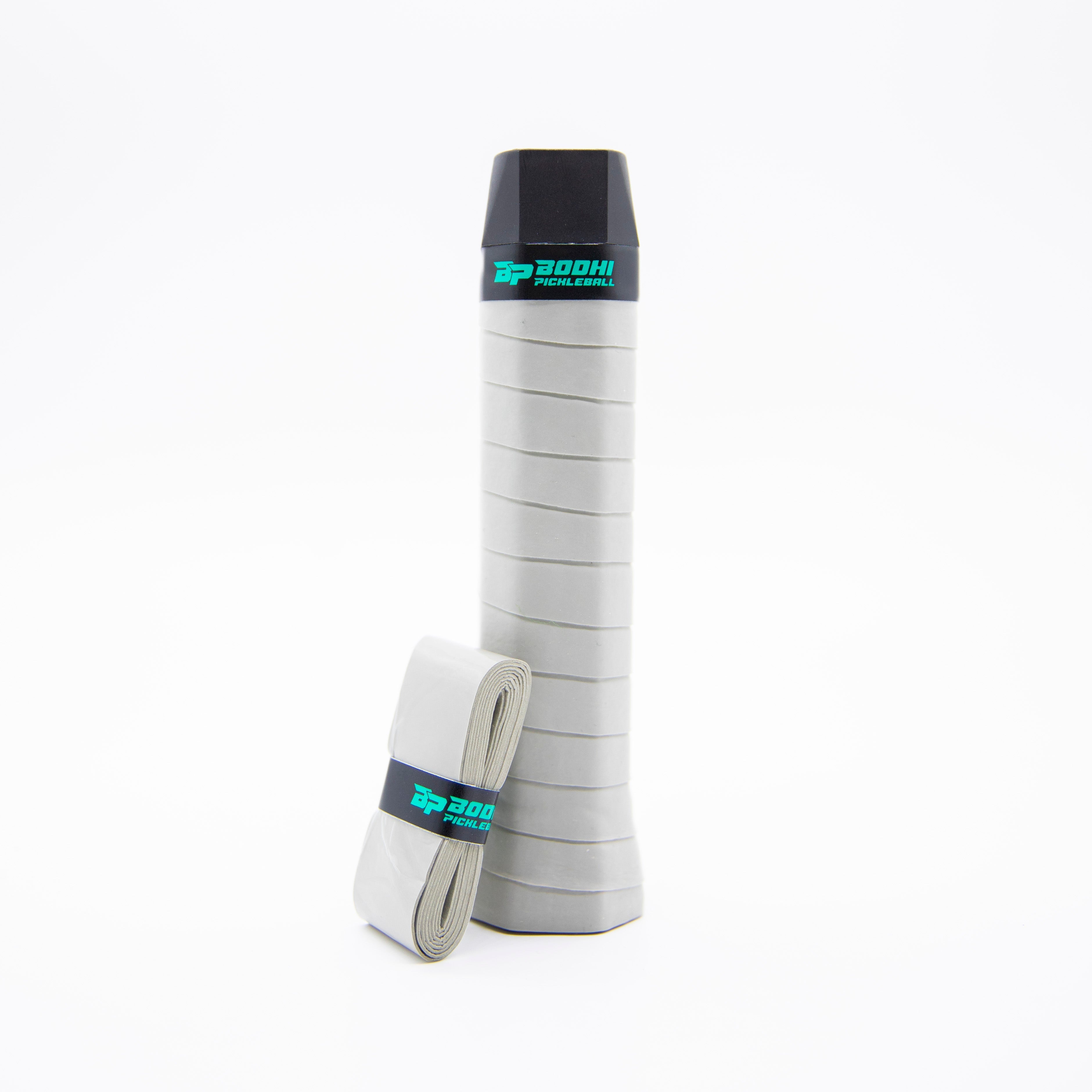 Gray pickleball grip with black cap and replacement roll.