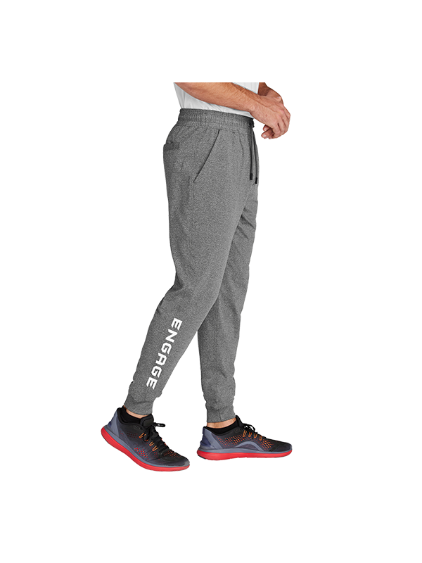 Gray heathered Men's Warmup Pants by EngagePickleball with 'ENGAGE' text vertically on the left leg, drawstring waist, and side pockets, worn by a man in sneakers.