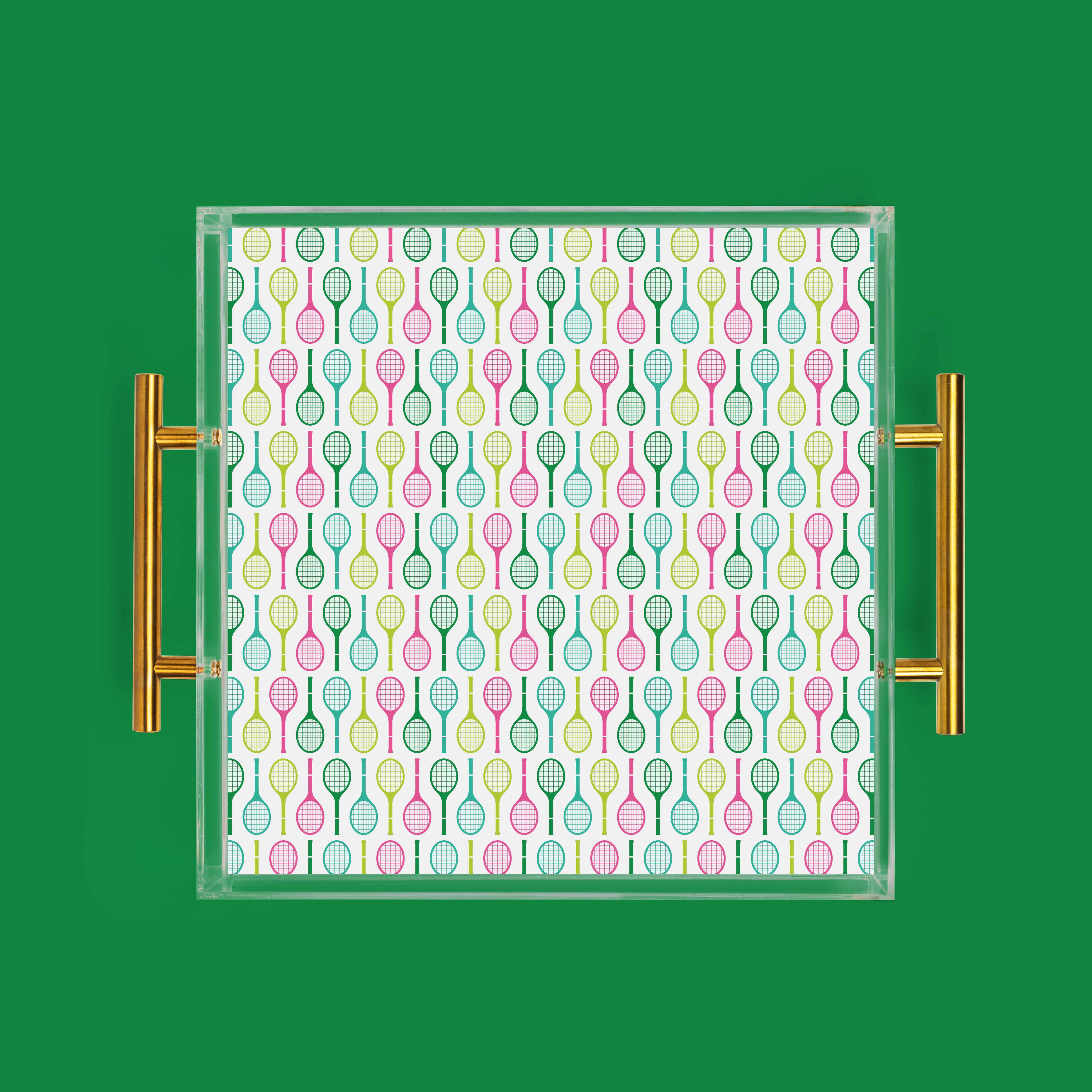 Acrylic tray with gold handles, patterned with tennis rackets.