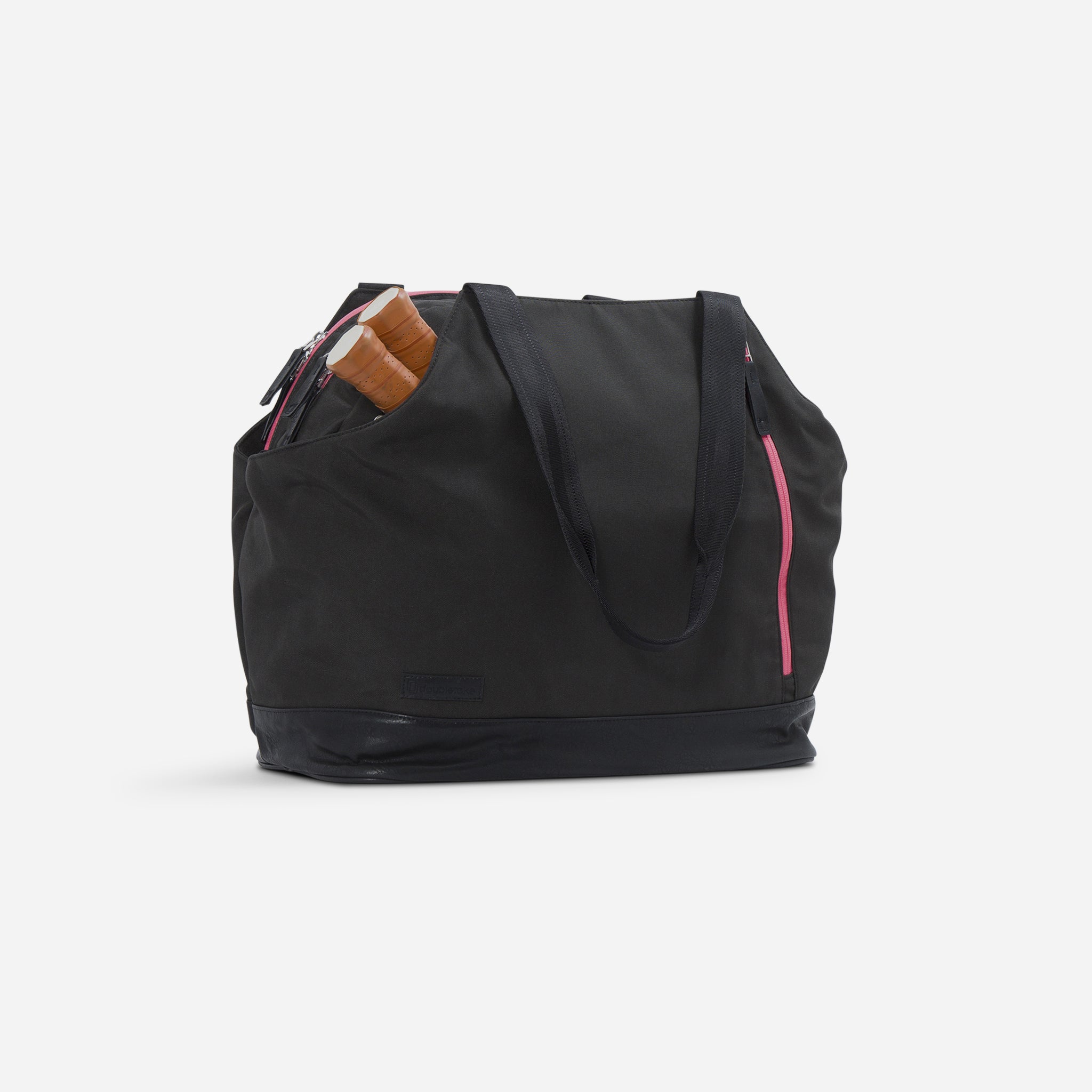 Black pickleball duffel tote bag by Doubletake, with pink zippers and exposed paddle handles.