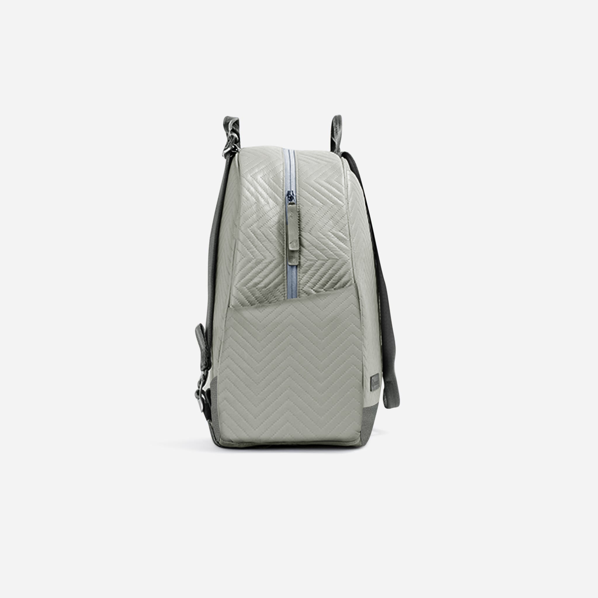 Light sage green pickleball backpack and tote by Doubletake, with a chevron pattern, front zipper, and dark grey accents, side view.
