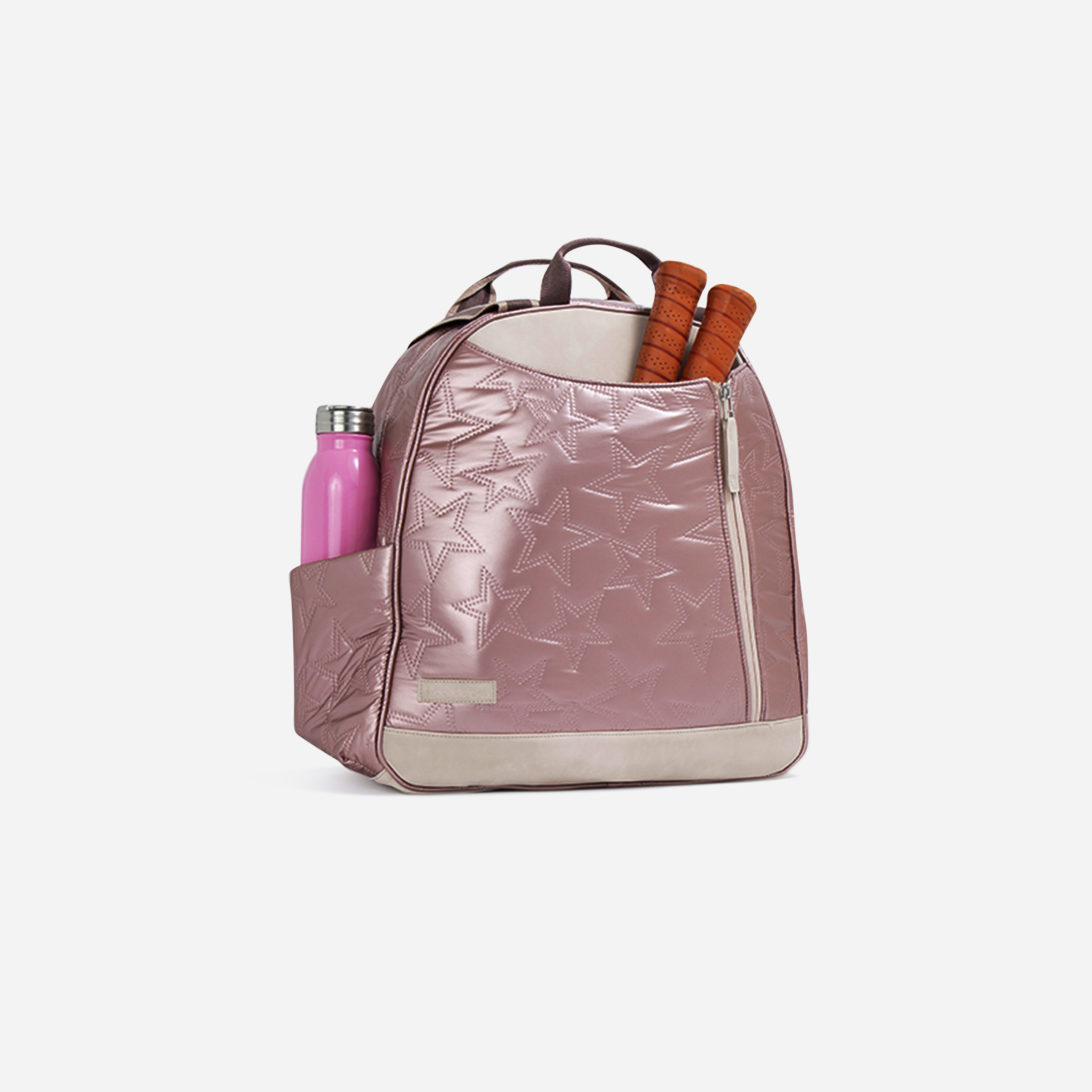 Rose gold quilted pickleball backpack and tote by Doubletake with star pattern, beige trim, holding a pink water bottle and two paddles.