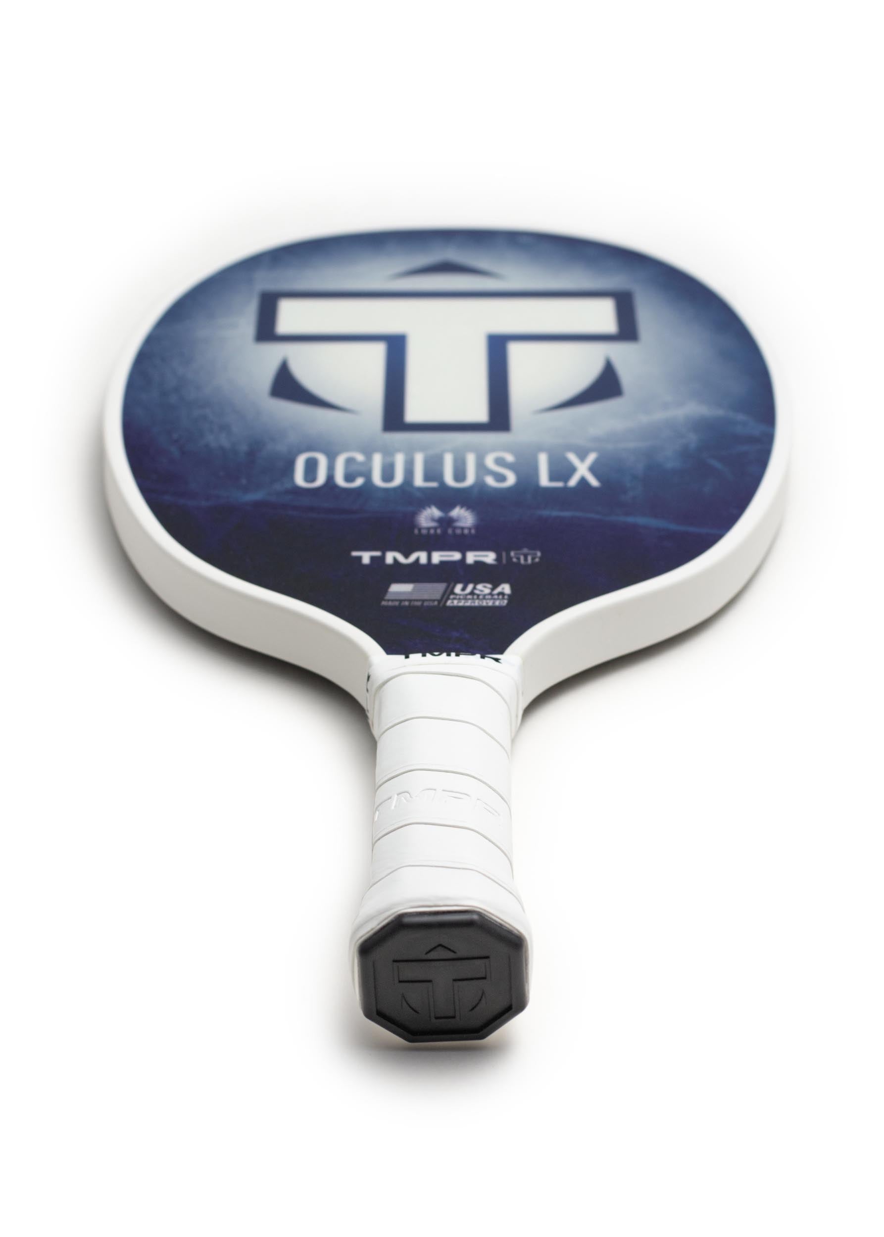 A white-edged pickleball paddle by TMPR Sports, featuring a dark blue Indigo Ice patterned face and a white grip.