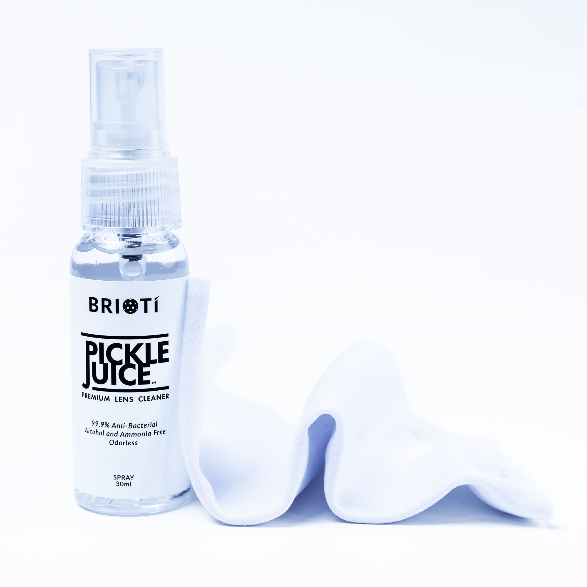 A small bottle of "Pickle Juice" premium lens cleaner with a spray nozzle and a white cleaning cloth.