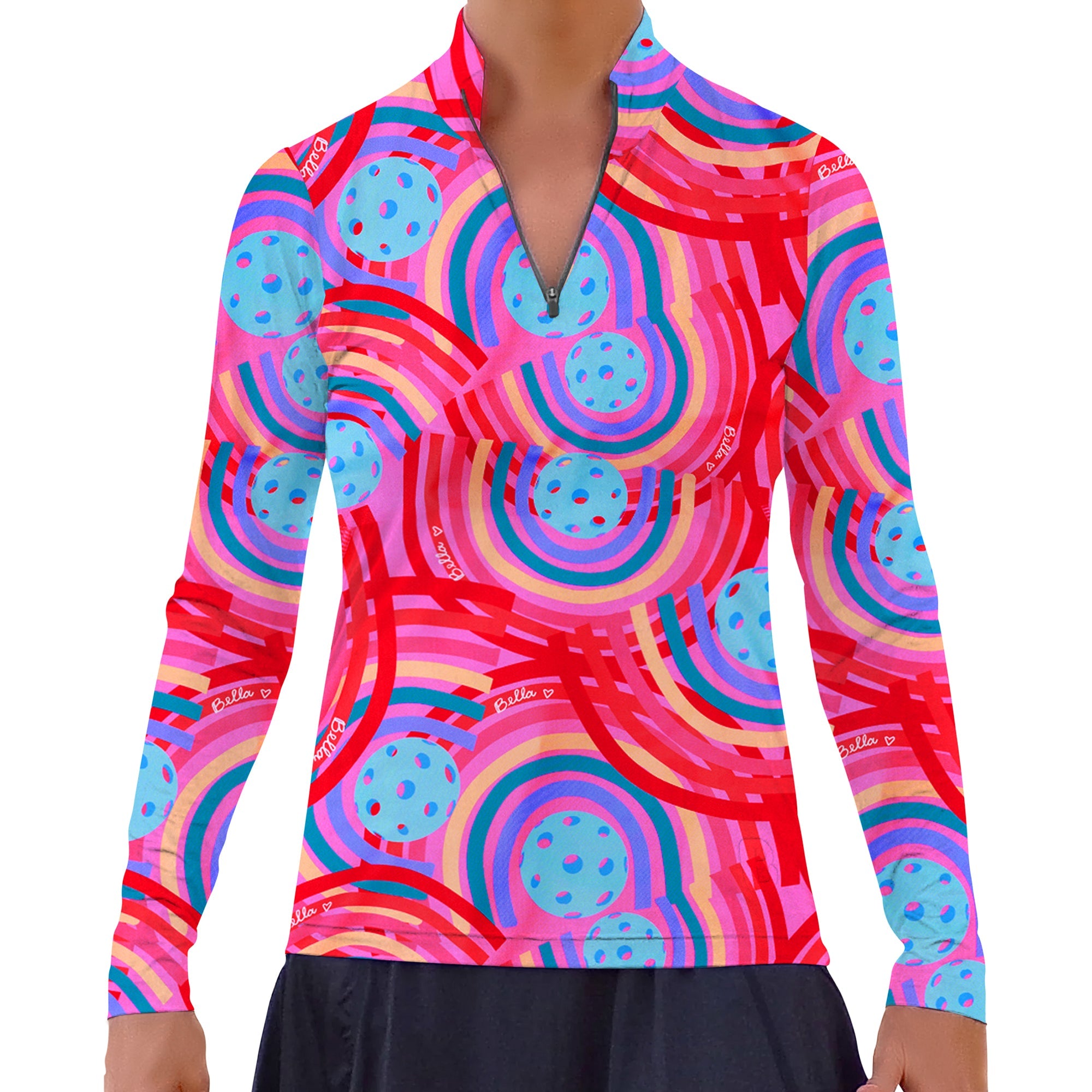 Vibrant pink 1/4 Zip Long Sleeve Pullover by Pickleball Bella, with a rainbow and pickleball ball pattern and 'Bella' text, worn with a black skirt.
