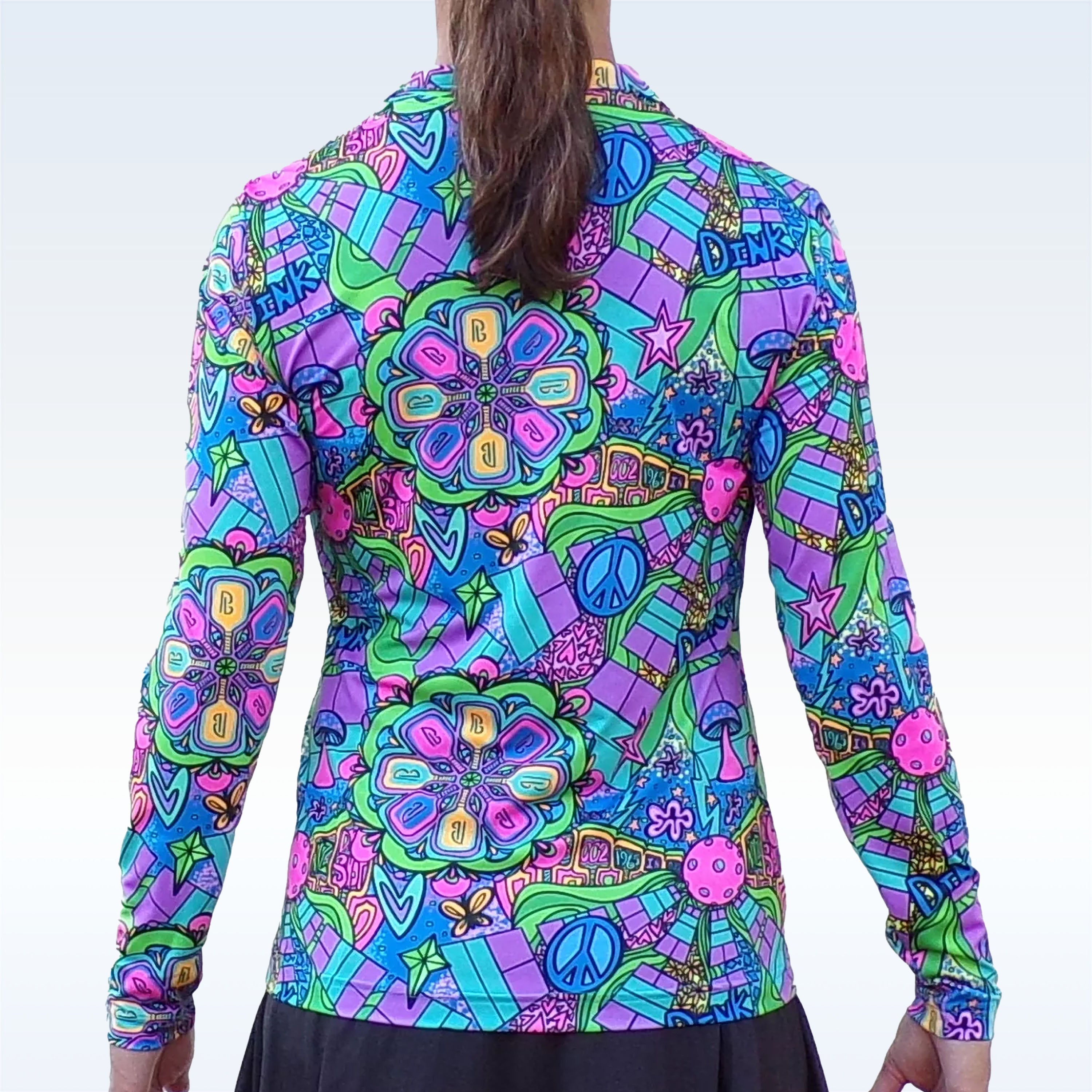 Long sleeve 1/4 zip pullover by Pickleball Bella, featuring a vibrant psychedelic pattern with peace signs, mushrooms, and 'B' motifs in purple, green, blue, and pink, back view.