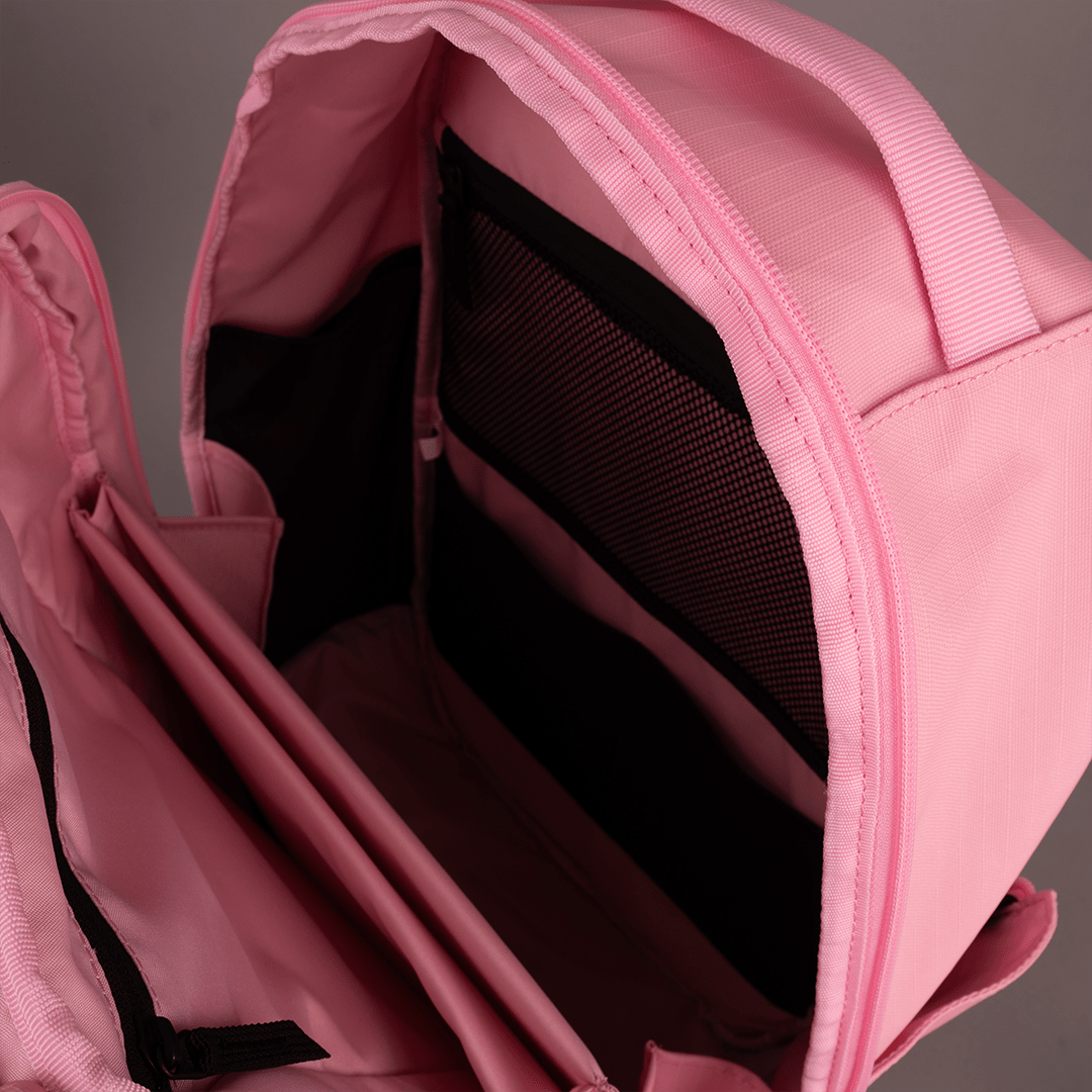Pink open pickleball backpack by FORWRD revealing multiple internal mesh and fabric pockets and dividers.
