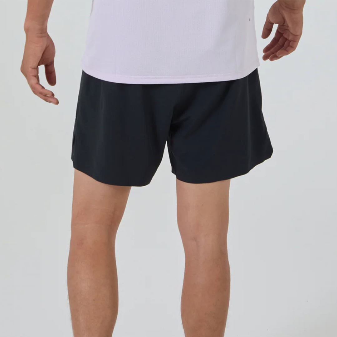 Person wearing lavender shirt and black athletic shorts from the rear.