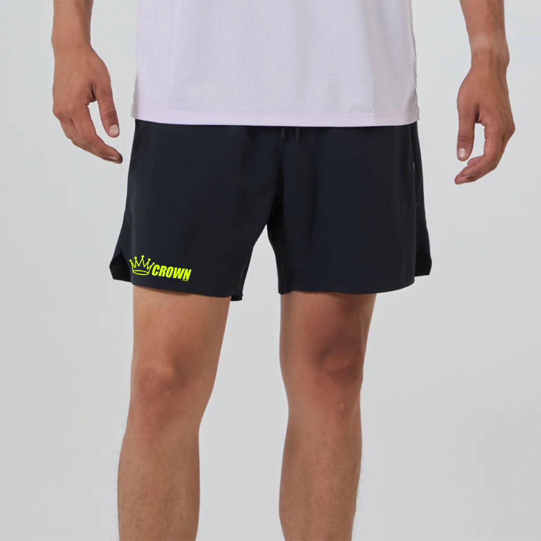 A man wearing black athletic shorts and a white shirt.