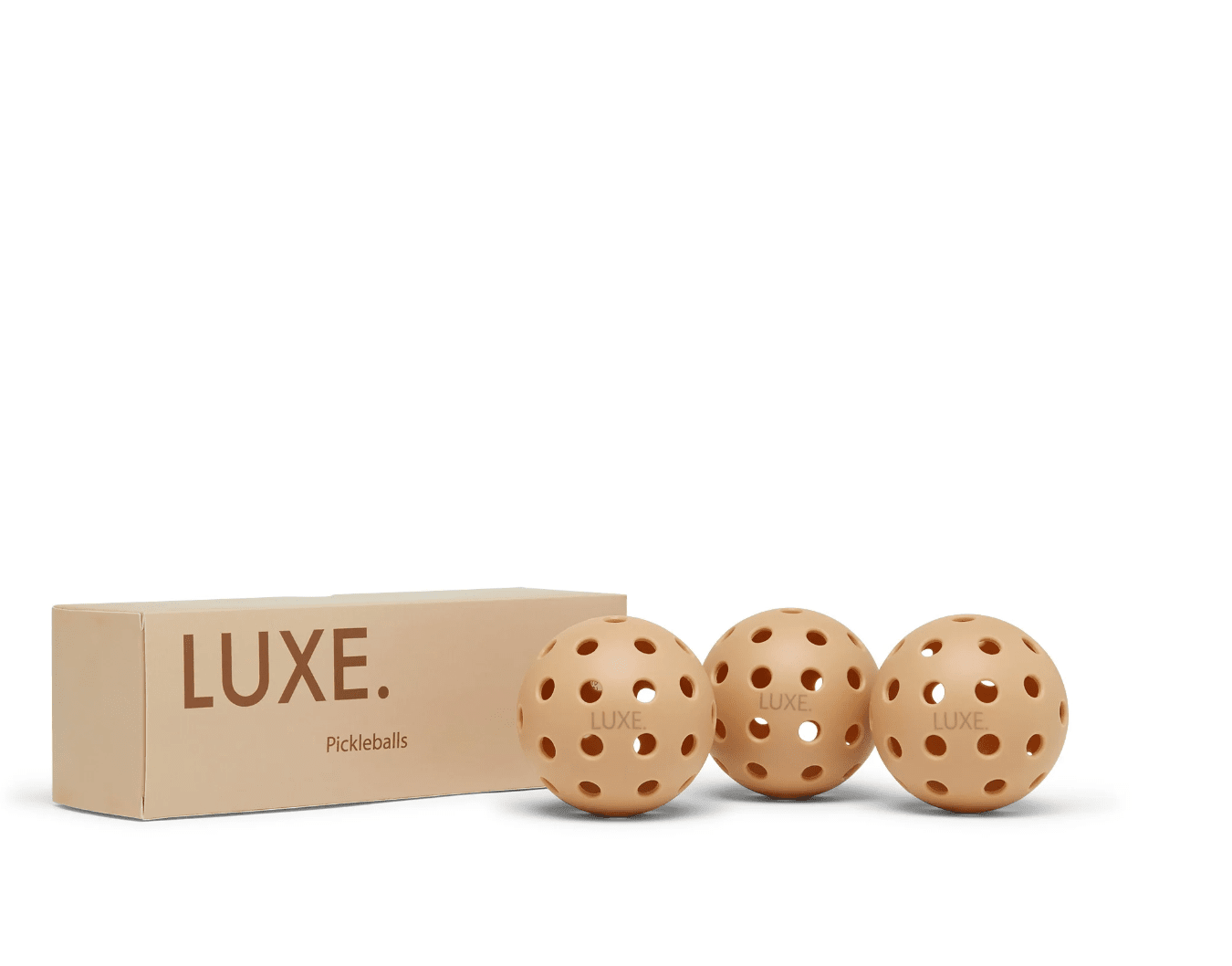 Tan box of Luxe pickleballs with three pickleballs.