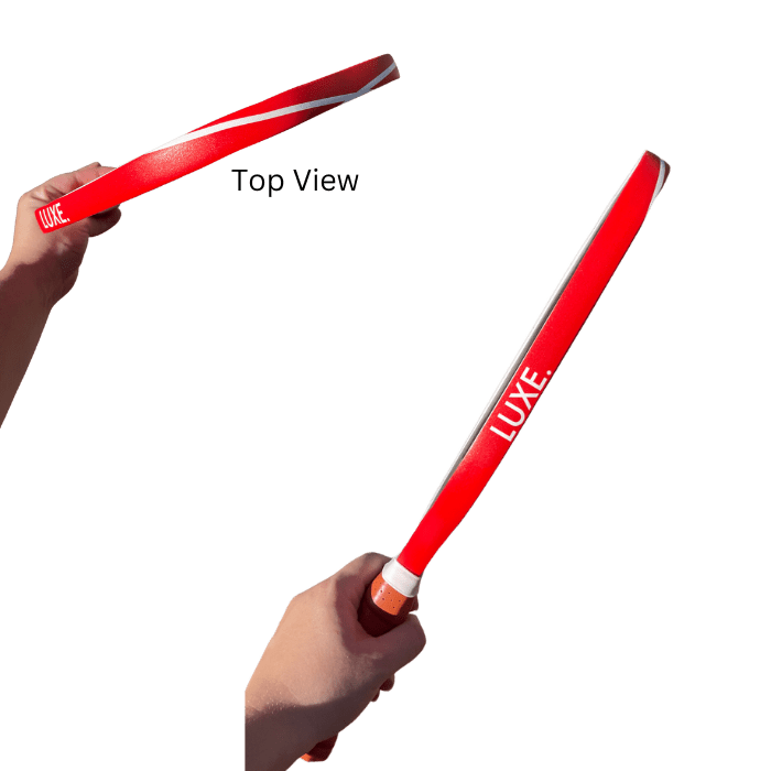 A person holding two red and white LUXE. branded paddle boards.