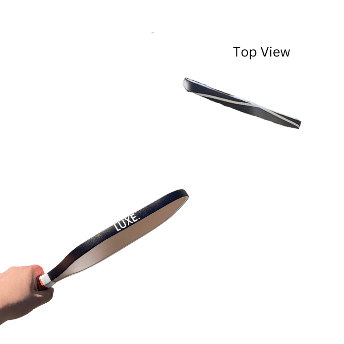 Hand holding a Luxe brand paddle with another paddle from above.