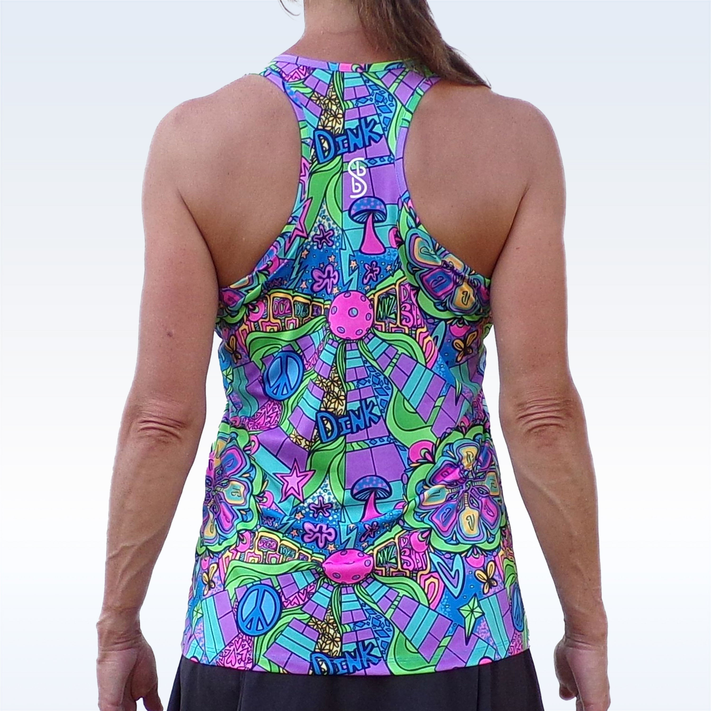 Multi-colored groovy racerback tank by Pickleball Bella, with a vibrant pattern including peace signs, mushrooms, 'DINK' text, and pickleball icons, shown from the back.