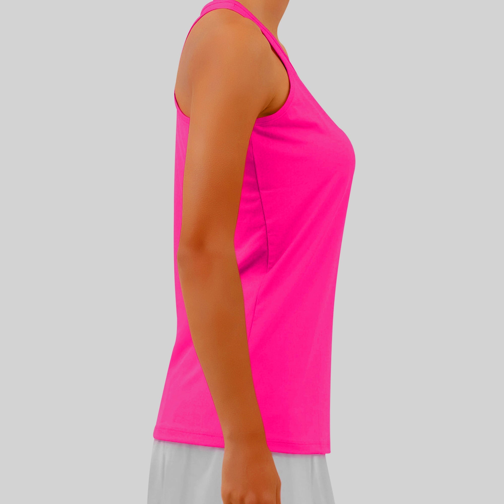 Hot Pink Racerback Tank by Pickleball Bella, worn in a side view with white shorts.