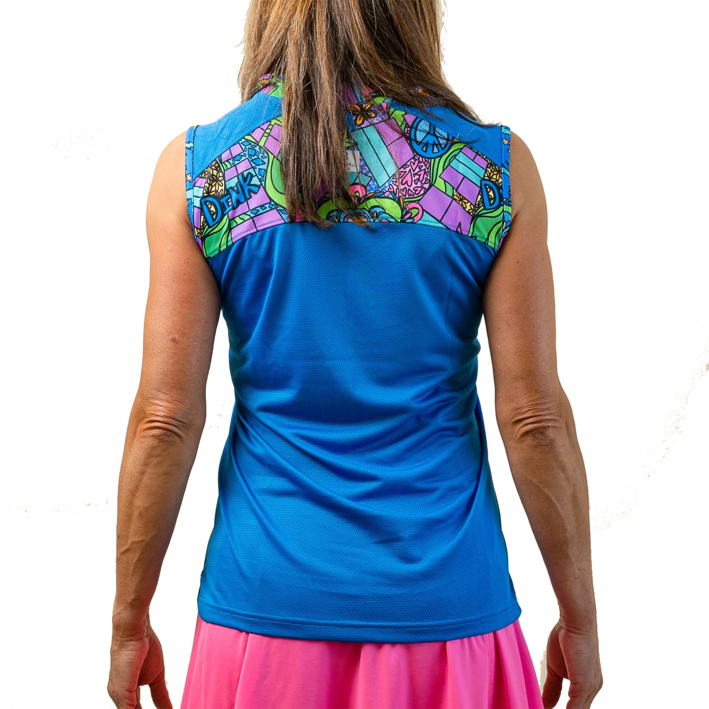 Blue 1/4 Zip Sleeveless by Pickleball Bella, featuring a vibrant groovy patterned back yoke, shown from the back over a pink skirt.