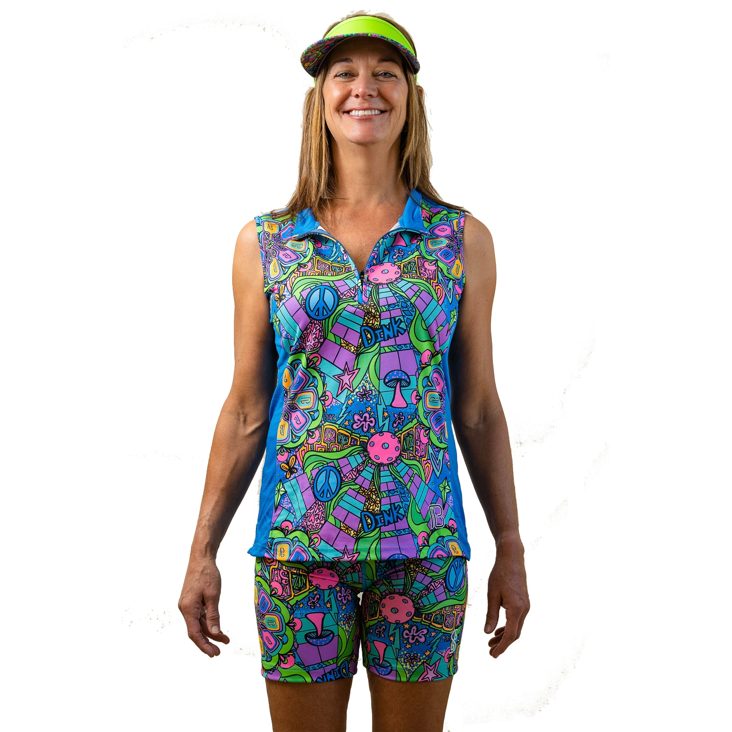 Colorful psychedelic 1/4 Zip Sleeveless top by Pickleball Bella, with peace signs and mushrooms in blue, green, and purple, worn with matching shorts and a neon green visor.