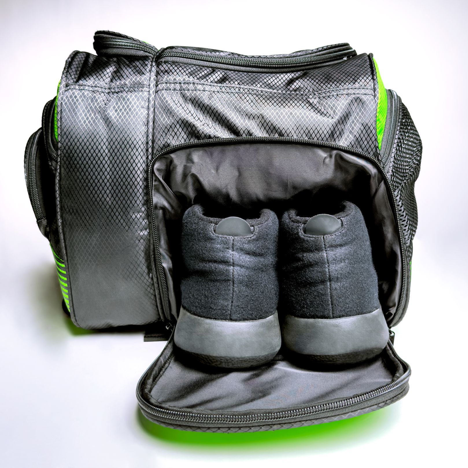 Gray and green gym bag with shoes inside.