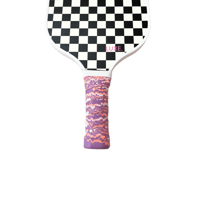 Pickleball paddle with black and white checkerboard face and purple and orange grip.